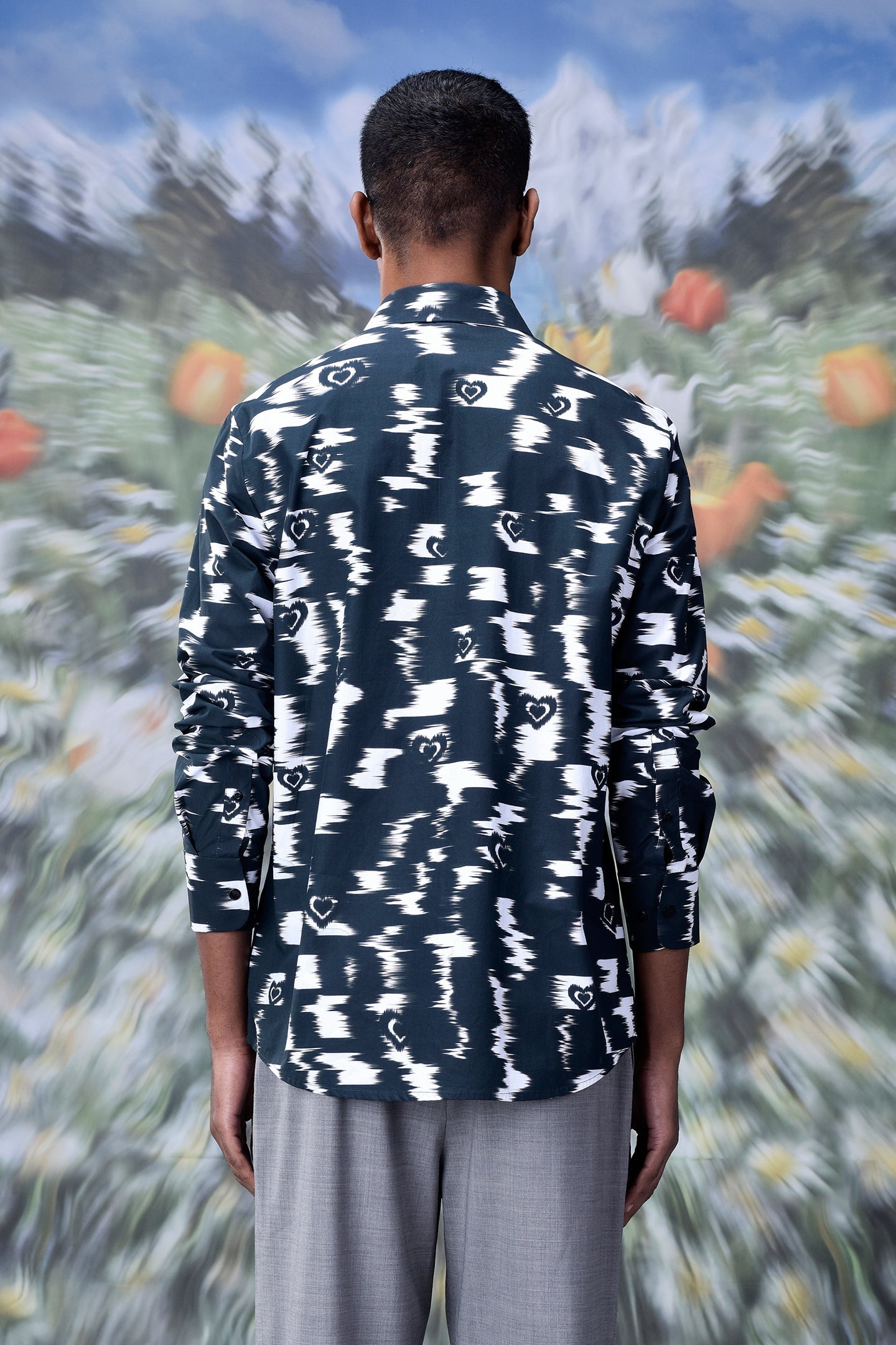 Back view of a man wearing a Stylera trendy printed shirts for men in black and white pattern