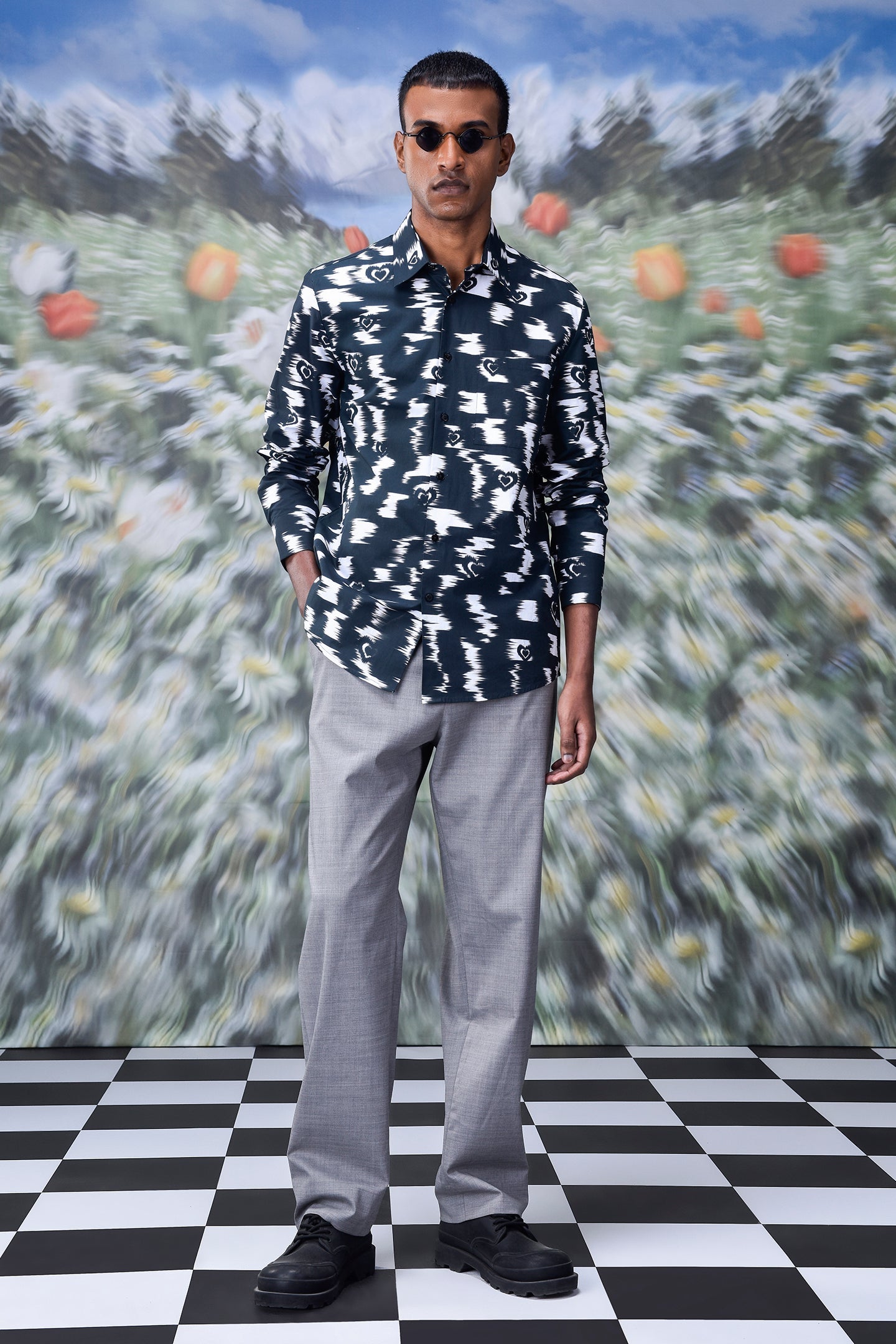 Man wearing trendy printed shirts for men by Stylera paired with gray pants and black shoes