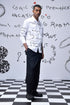 Trendy scribble print shirt by Stylera worn by male model with black pants