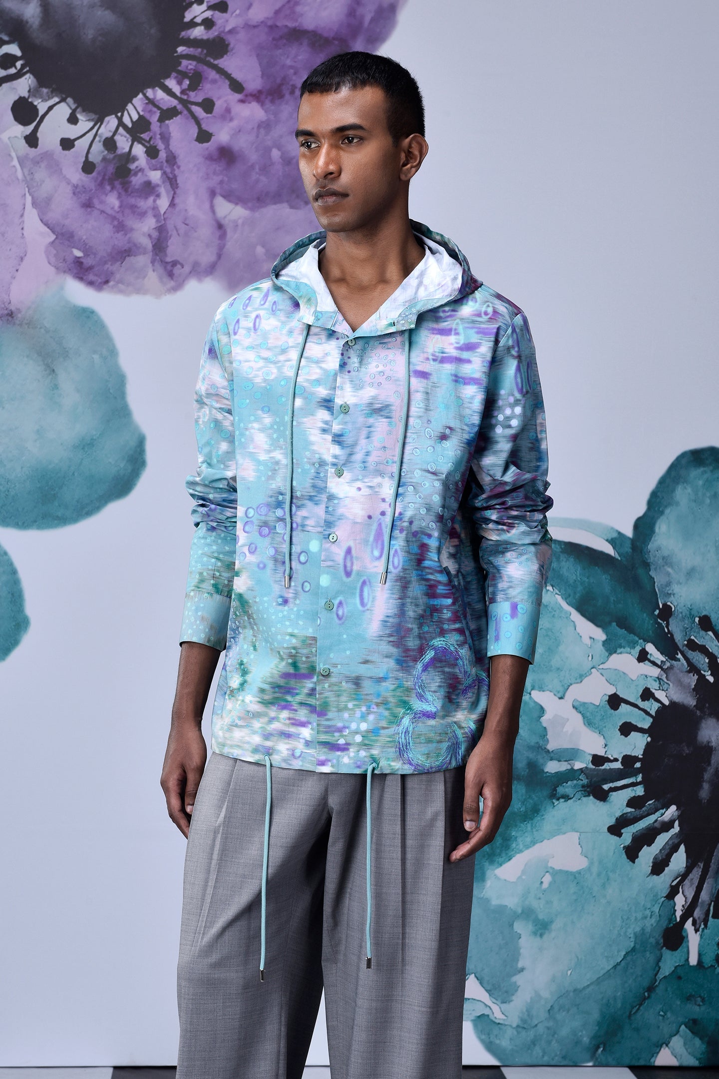Stylera artistic print hoodie shirt in aqua purple watercolor pattern on male model with hooded long sleeves