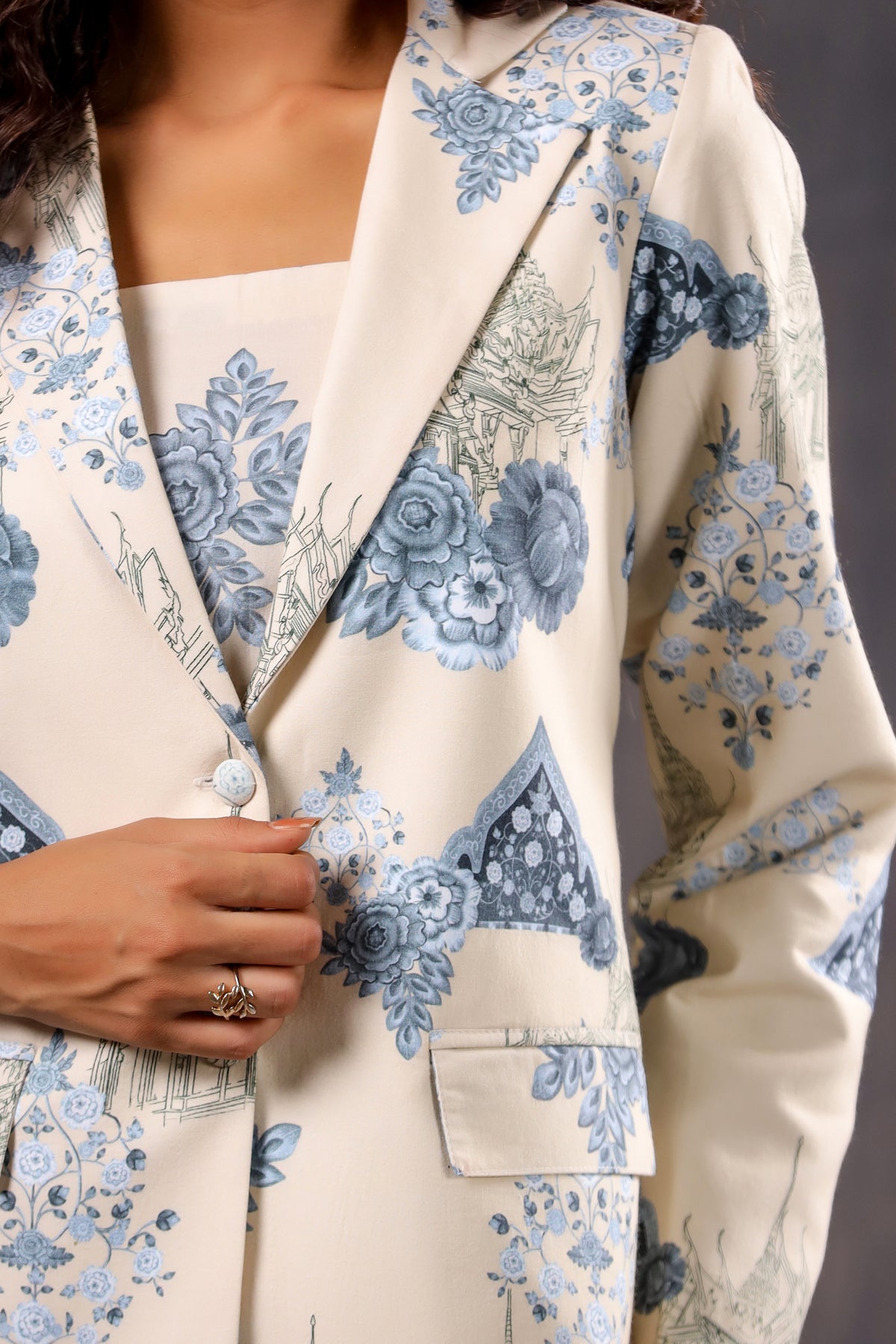 Close up of Stylera blazer and bandeau from Floral print two piece set for ladies. Cream jacket with blue floral pattern
