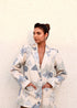 Stylera cream floral blazer worn by model against textured wall trendy fashion blazers for women