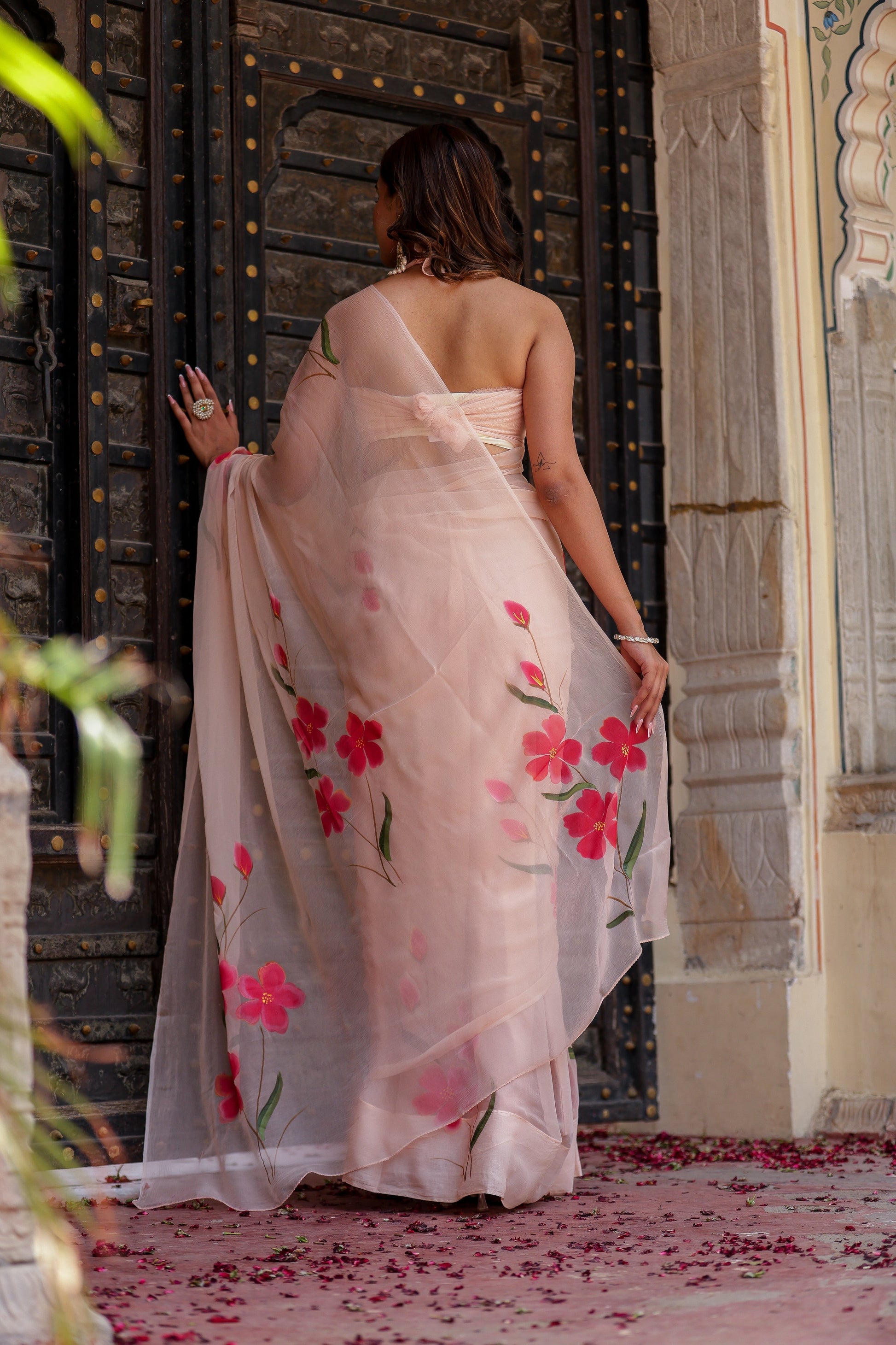 Elegant beige floral chiffon saree with pink floral prints perfect for special occasions