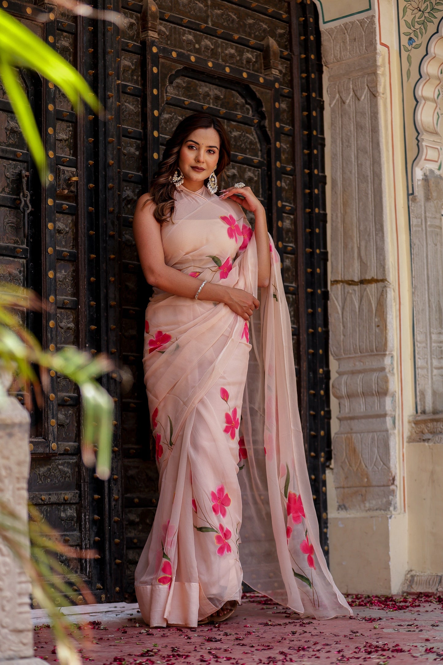 Elegant beige floral chiffon saree with pink flowers, perfect for festive occasions and celebrations