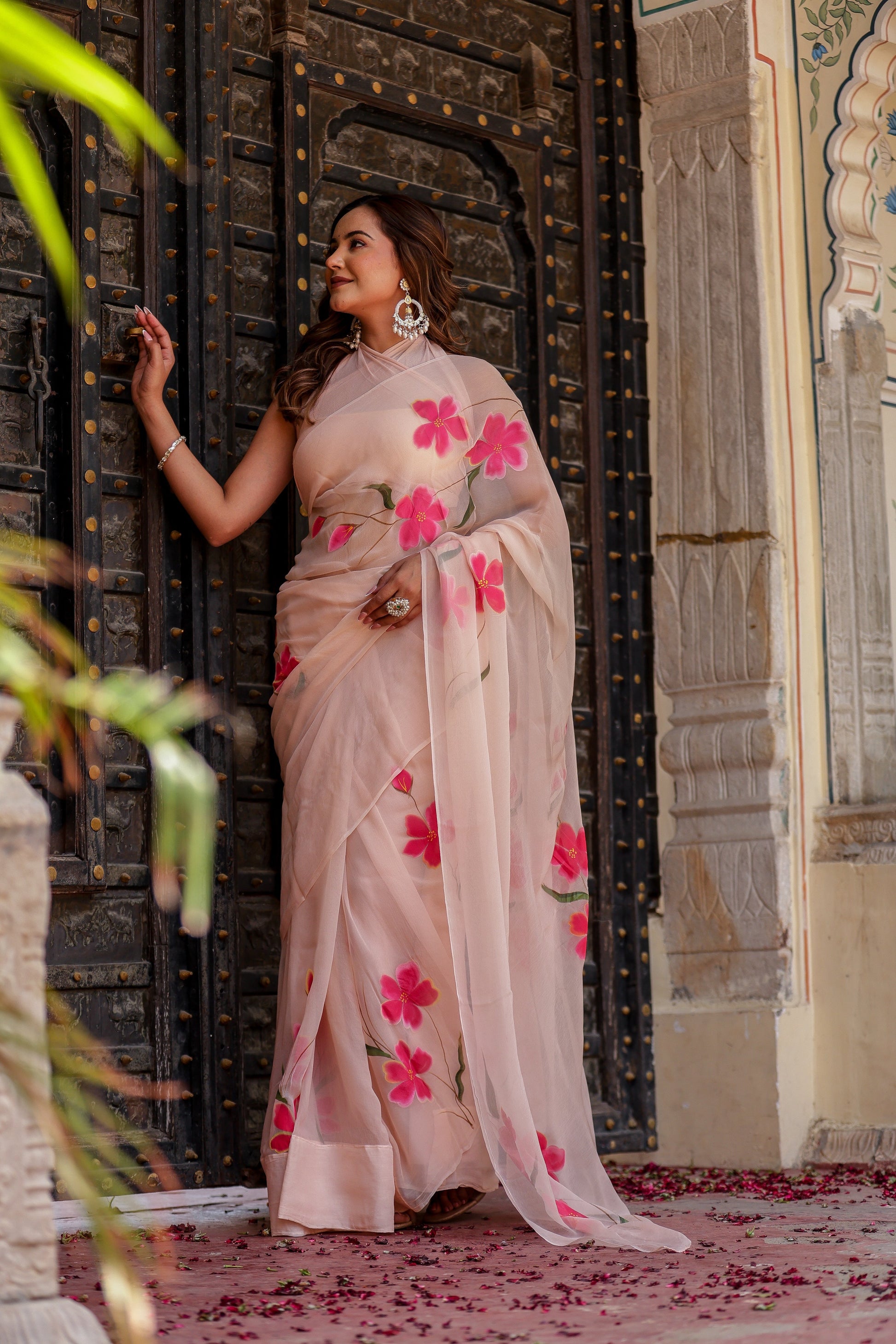 Elegant beige floral chiffon saree adorned with pink flowers, perfect for festive occasions