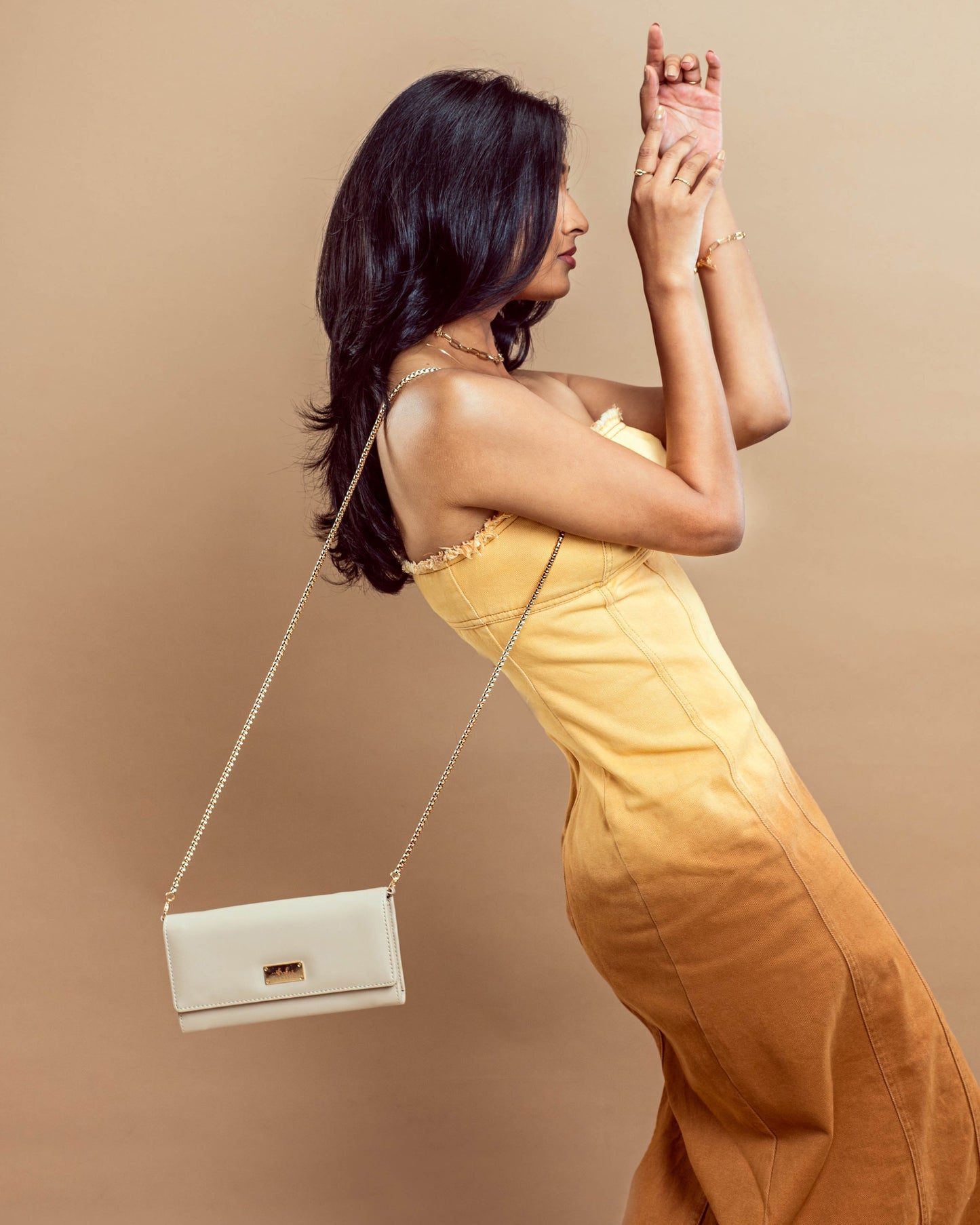 Stylish Stylera beige wallet with chain for women, worn as a sling bag