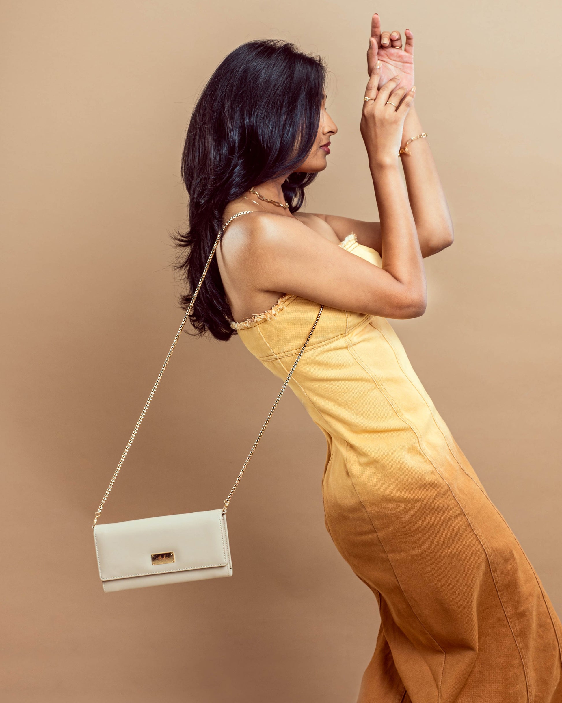 Stylish Stylera beige wallet with chain for women, worn as a sling bag