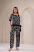 Stylera black and white two piece outfit featuring a stylish giraffe print top and matching pants