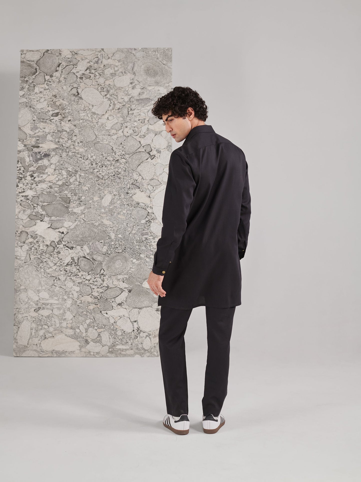 Stylish black kurta set for men featuring a modern cut and sleek design for versatile occasions