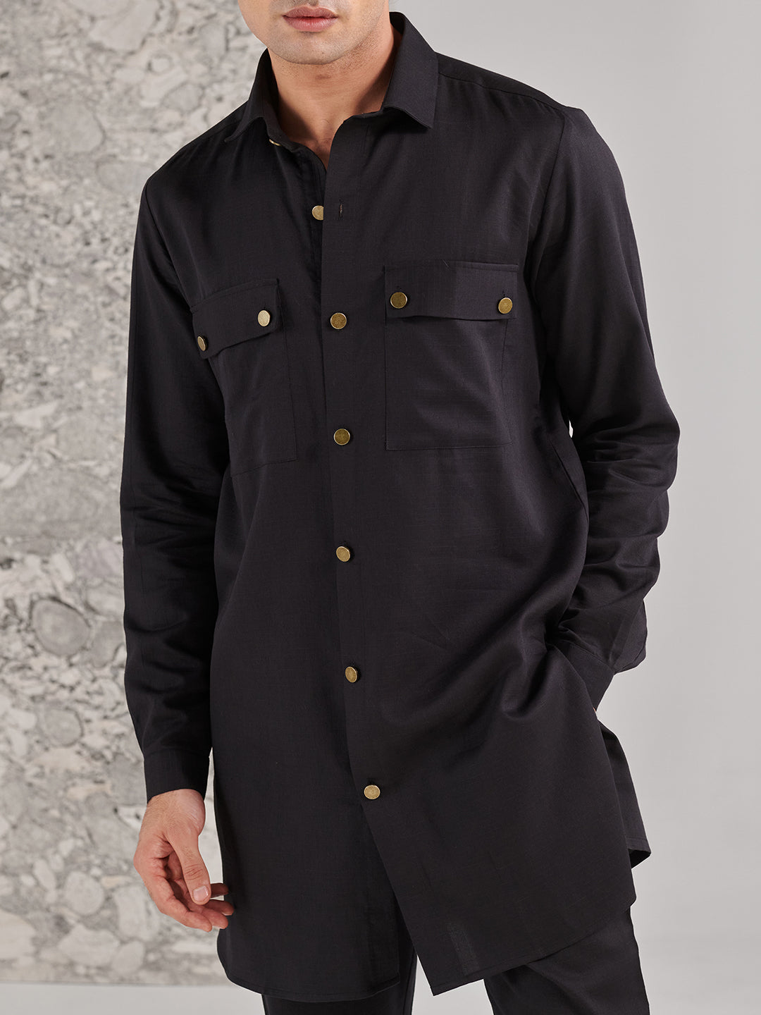 Stylish black kurta set for men with buttoned pockets and a modern silhouette by Stylera
