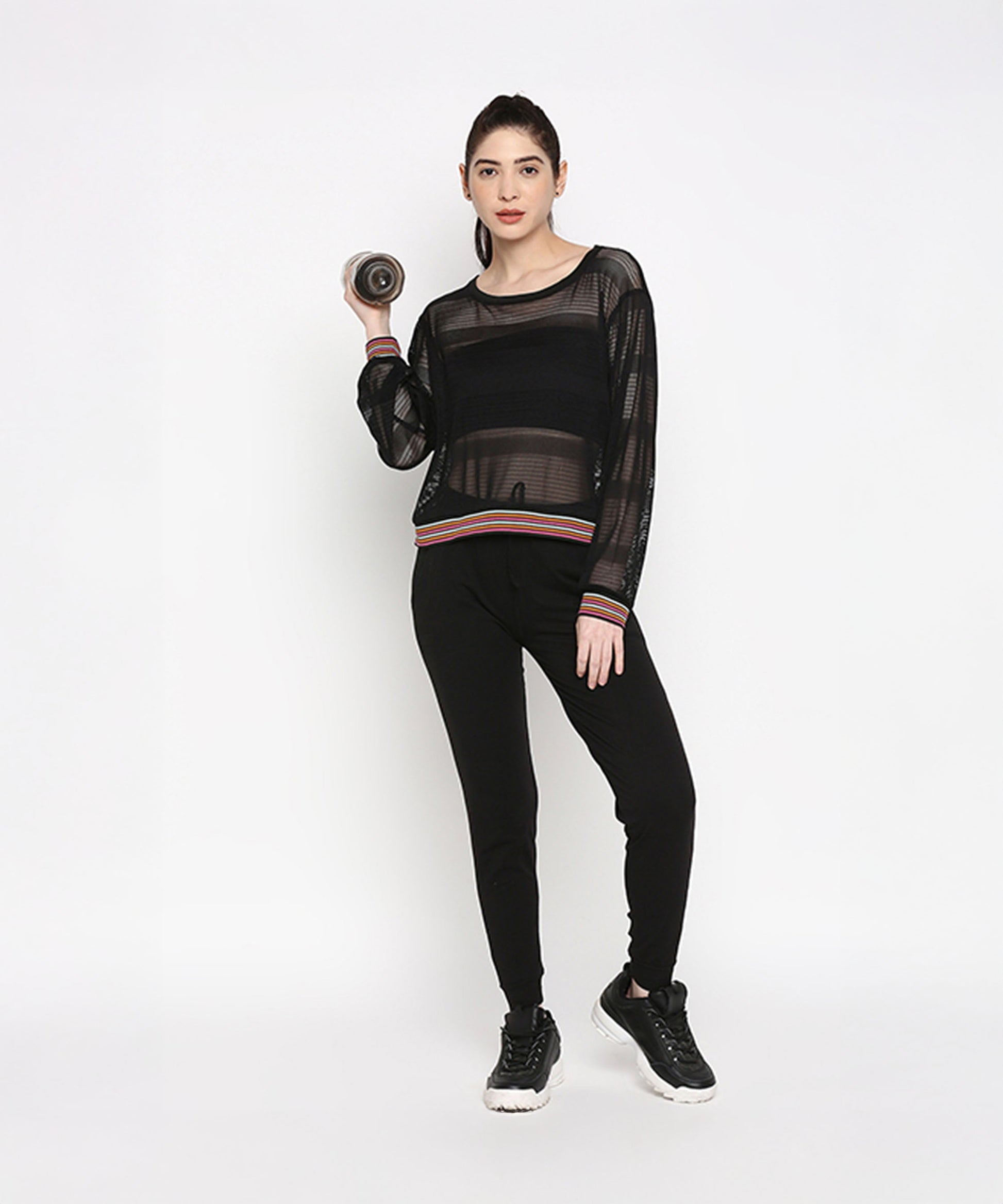 Stylish black netted top for women paired with black joggers, perfect for activewear outfits