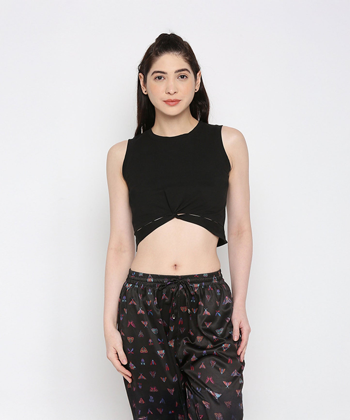 Stylera black twisted crop top featuring a stylish knotted front and sleeveless design