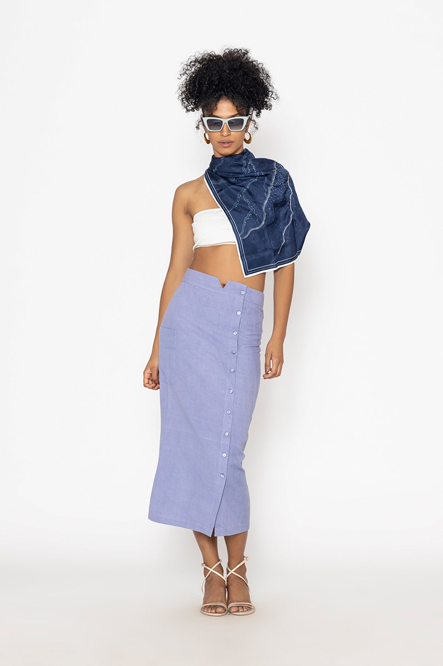 Stylera blue button front midi skirt worn with white crop top and navy scarf