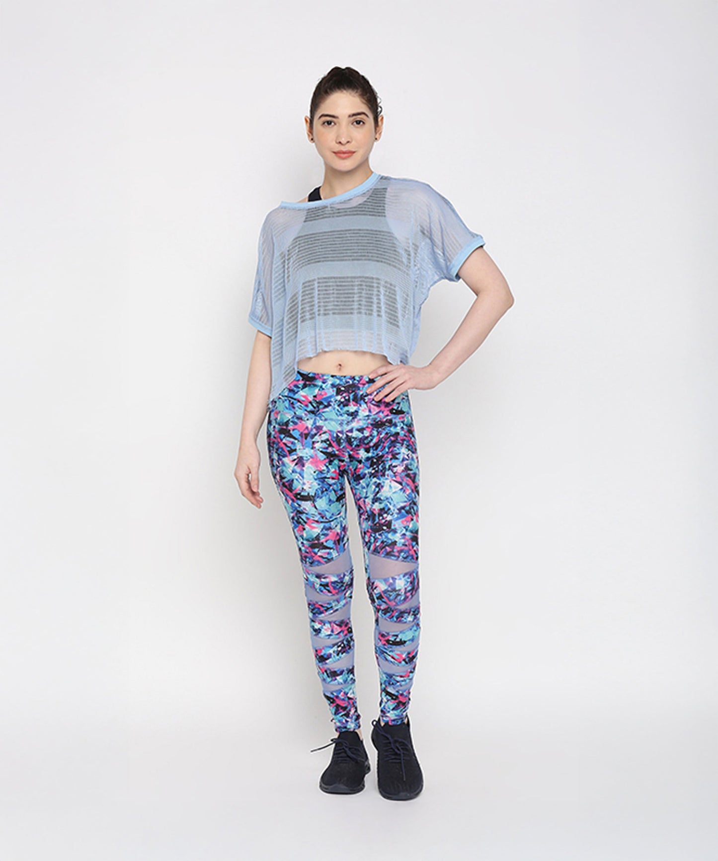 Blue netted top for women paired with vibrant floral leggings for a stylish workout look
