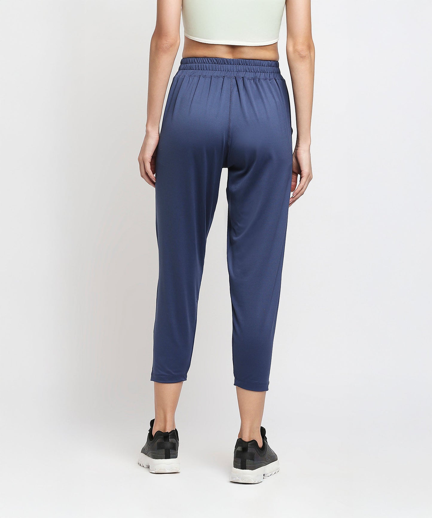 Back view of blue yoga pants for women with a comfortable elastic waistband and stylish cropped design