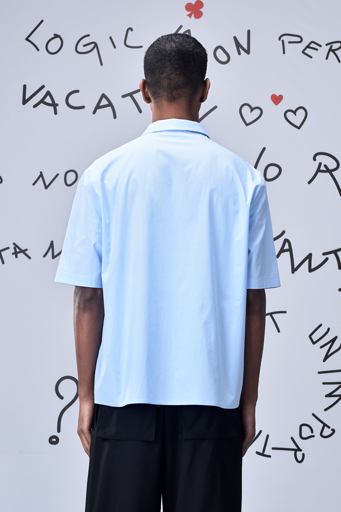 Back view of a man wearing a light blue relax fit shirt for men by Stylera