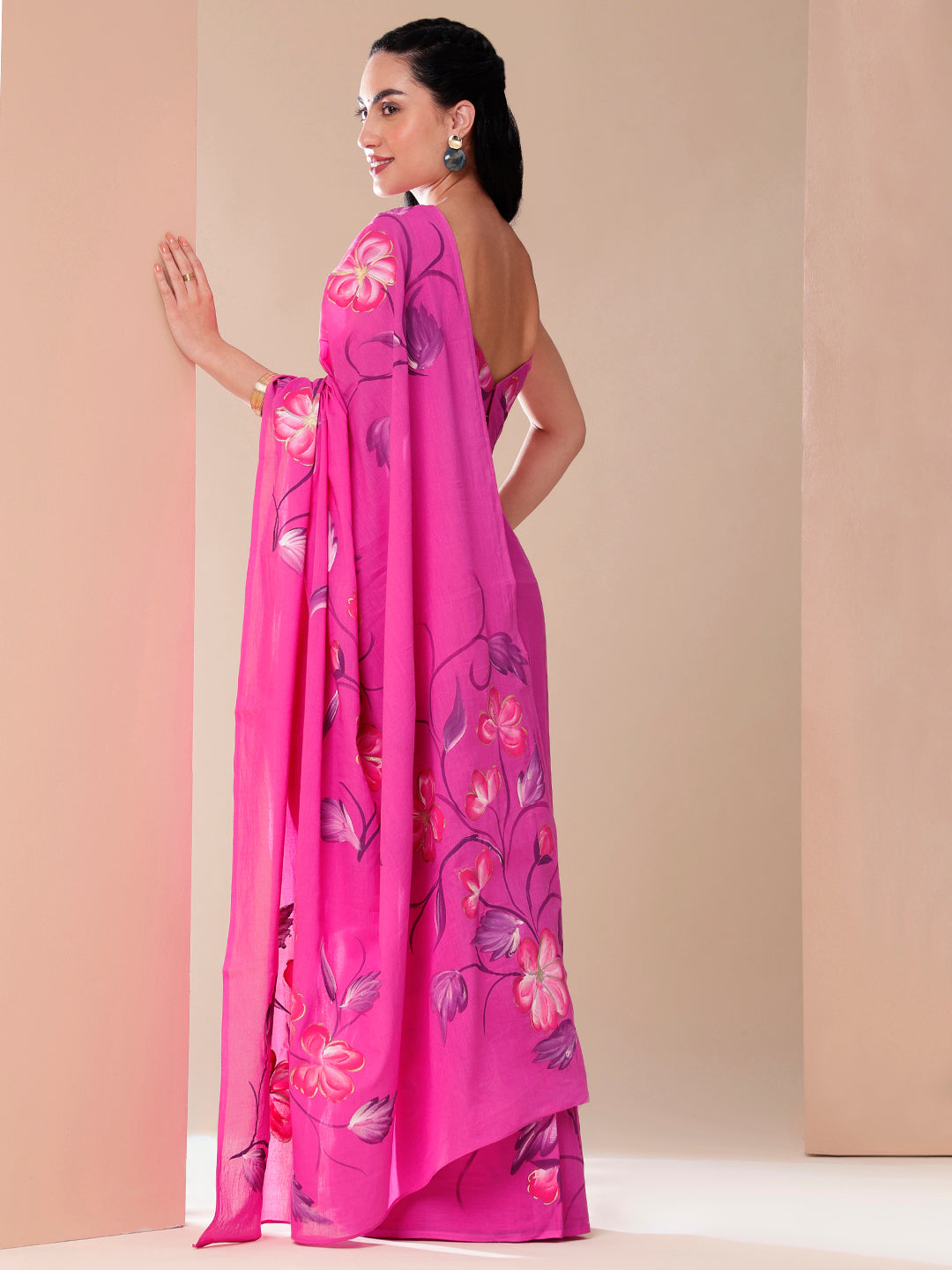 Calm Canvas floral saree in vibrant pink with intricate floral patterns, styled elegantly for special occasions