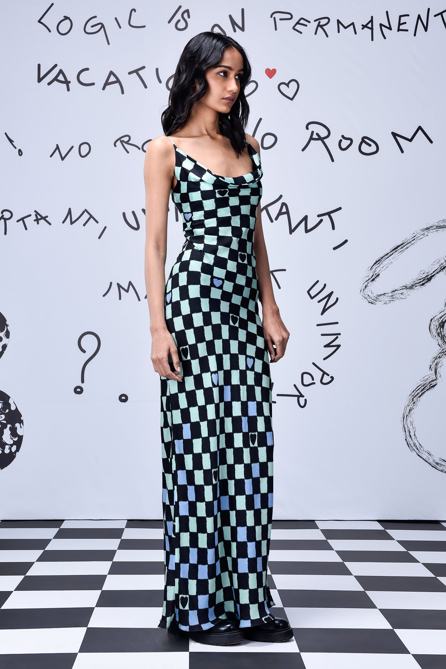 Model in Stylera chess board cowl neck dress black and mint check floor length with straps