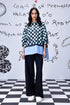 Stylera chess board print oversized shirt on model with layered blue hem and wide black trousers