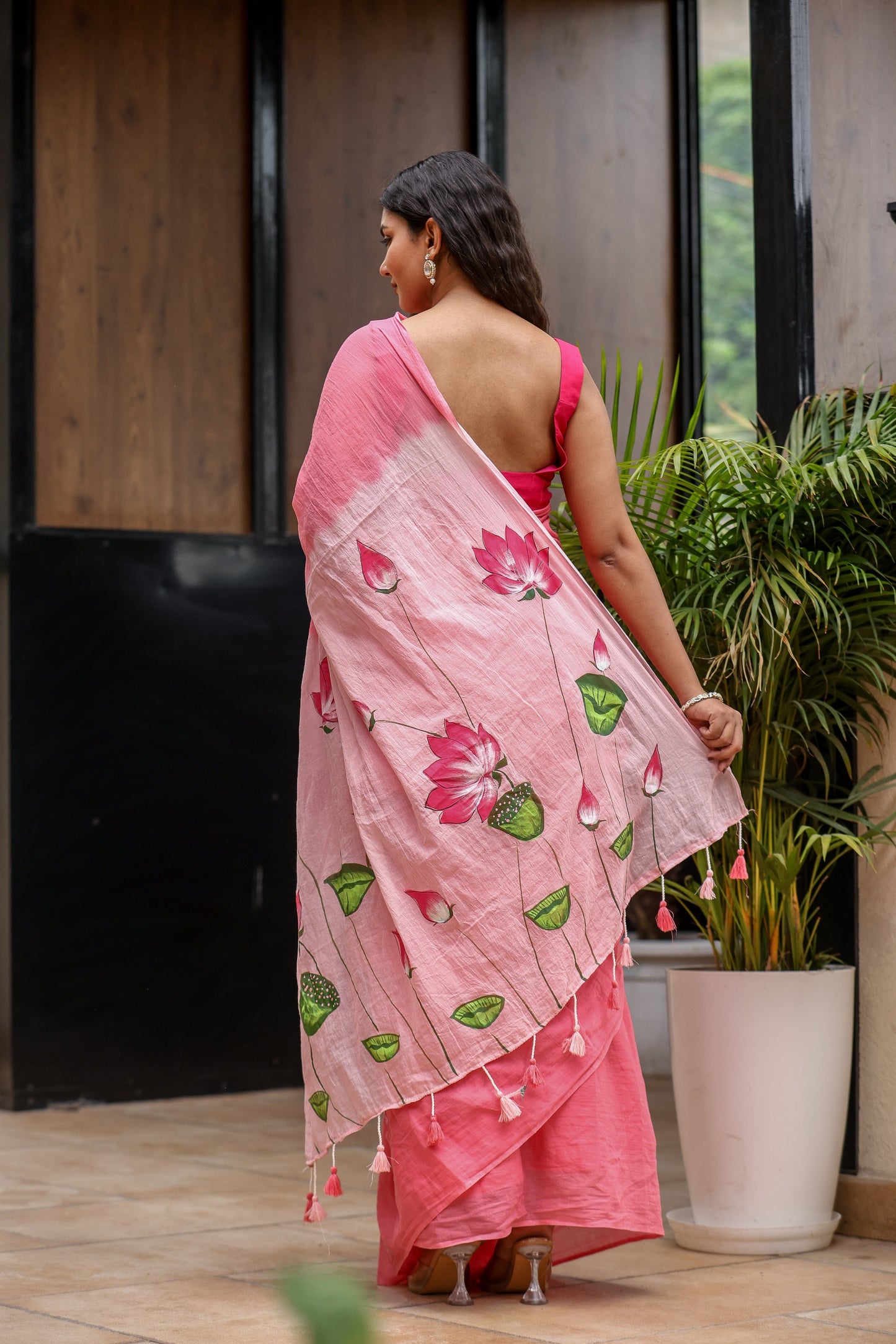 Pink cotton malmal saree with blouse featuring floral prints and tassels for a stylish look