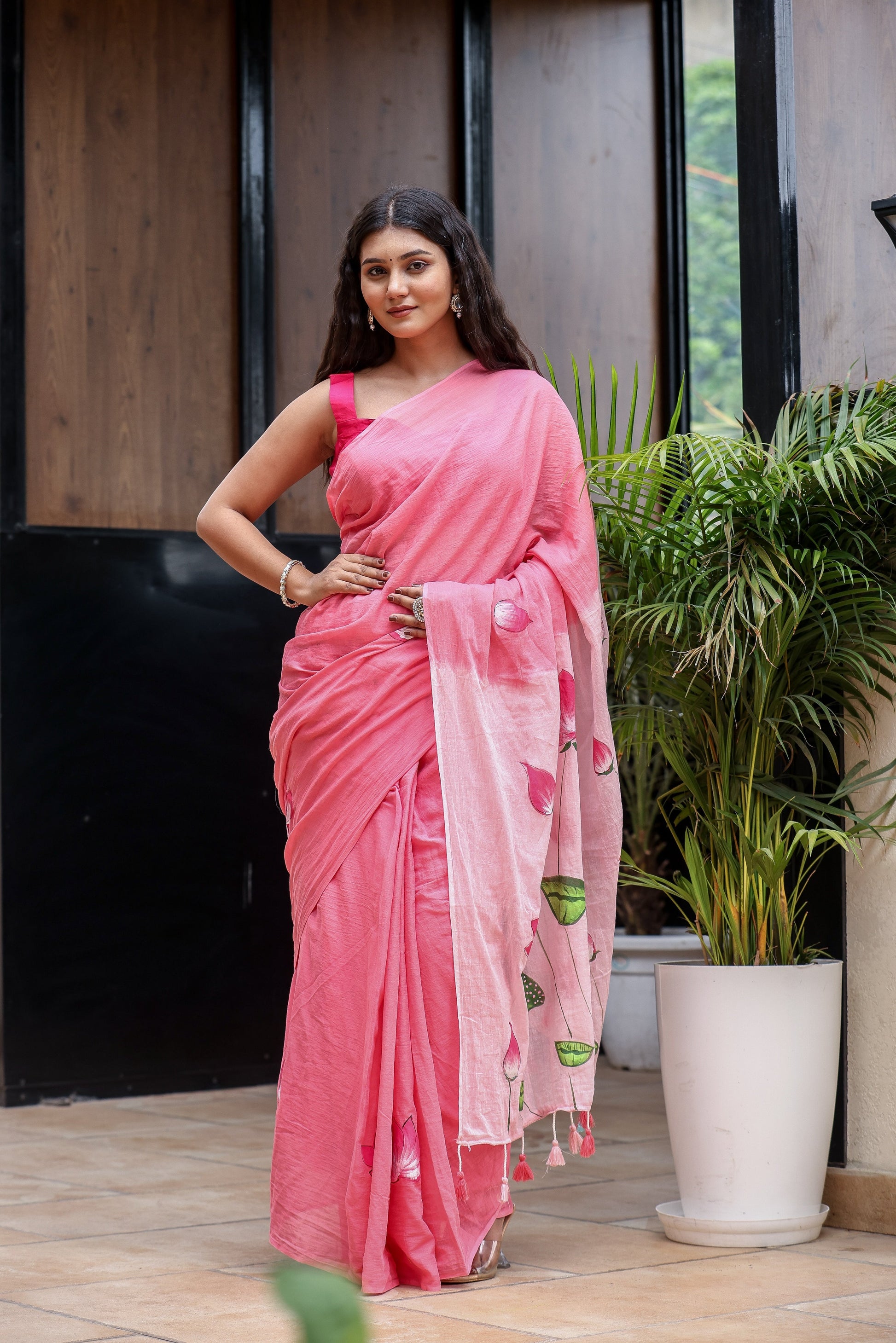 Elegant pink cotton malmal saree with blouse, featuring floral designs, perfect for festive occasions