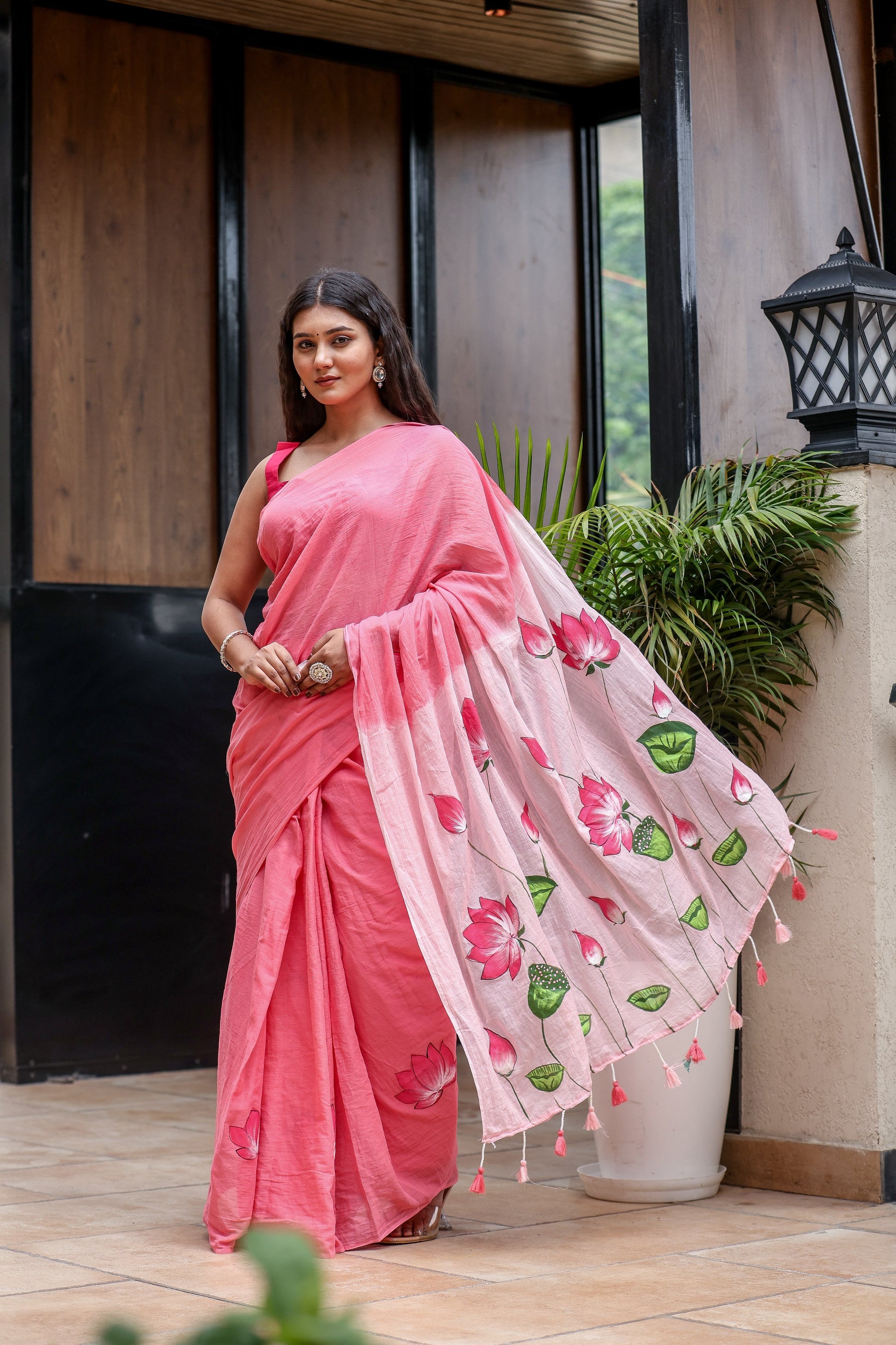 Stylera Cotton Malmal Saree with Blouse in Pink, featuring floral designs and tassels.