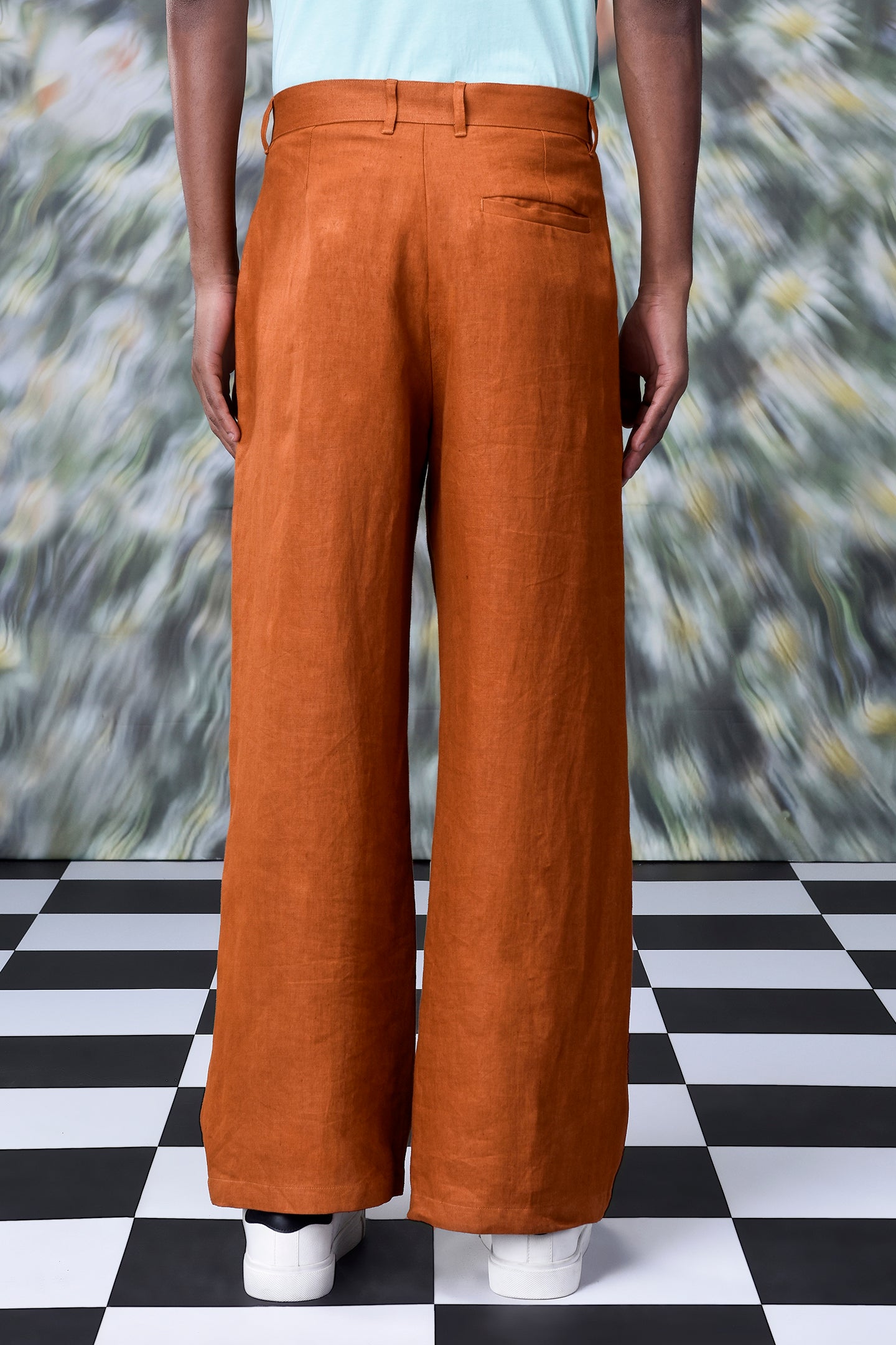 Back view of Stylera dark camel linen trousers with wide legs and belt loops