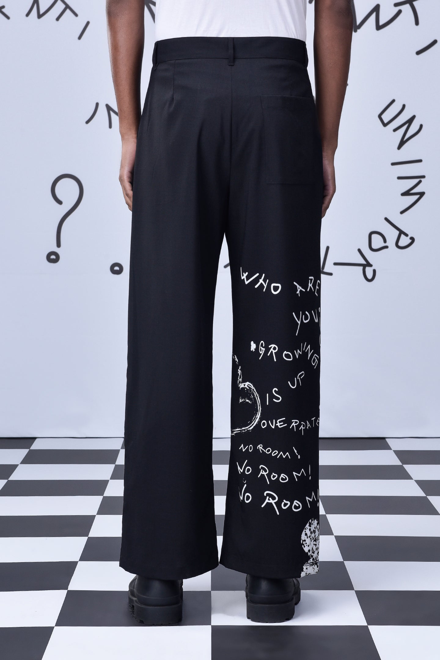 Designer black wool trousers by Stylera with white graphic text on the right leg