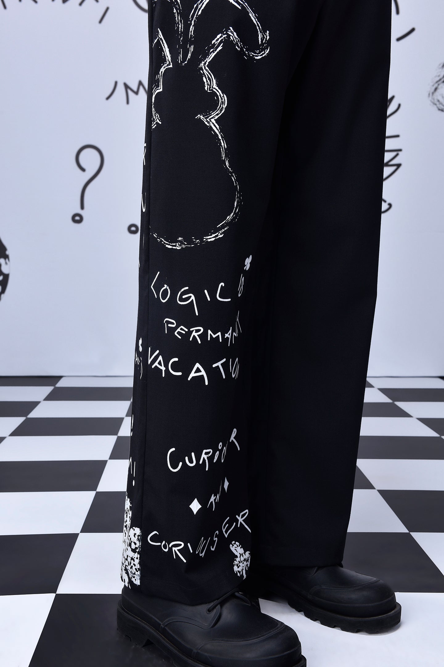 Stylera designer black wool trousers with artistic white text and graphic details