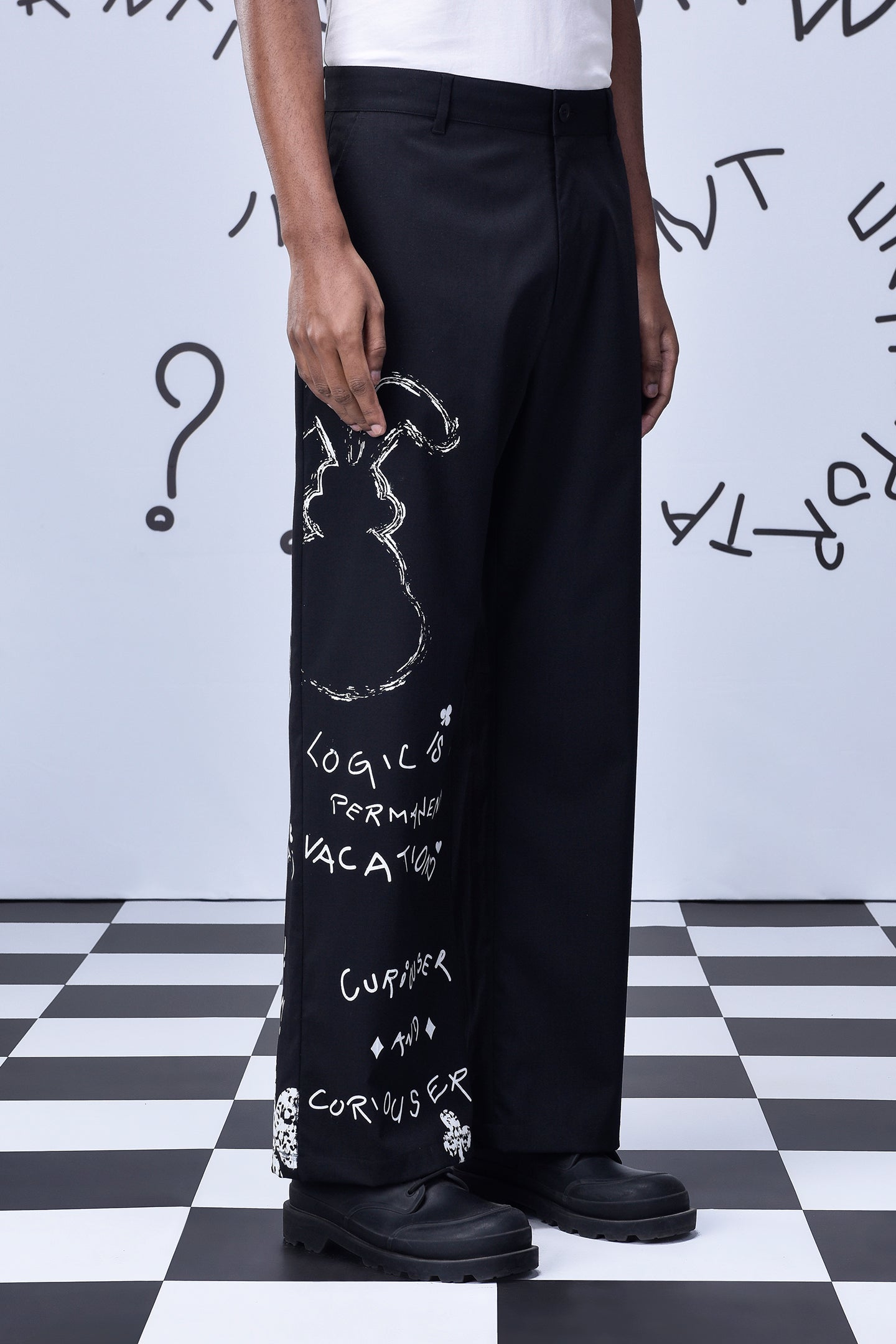 Designer black wool trousers by Stylera with white abstract graffiti print on leg