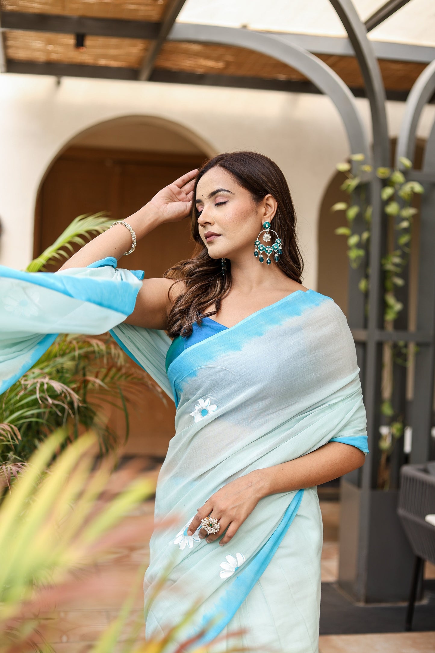 Elegant Stylera designer handpainted saree for parties in soft blue with floral details