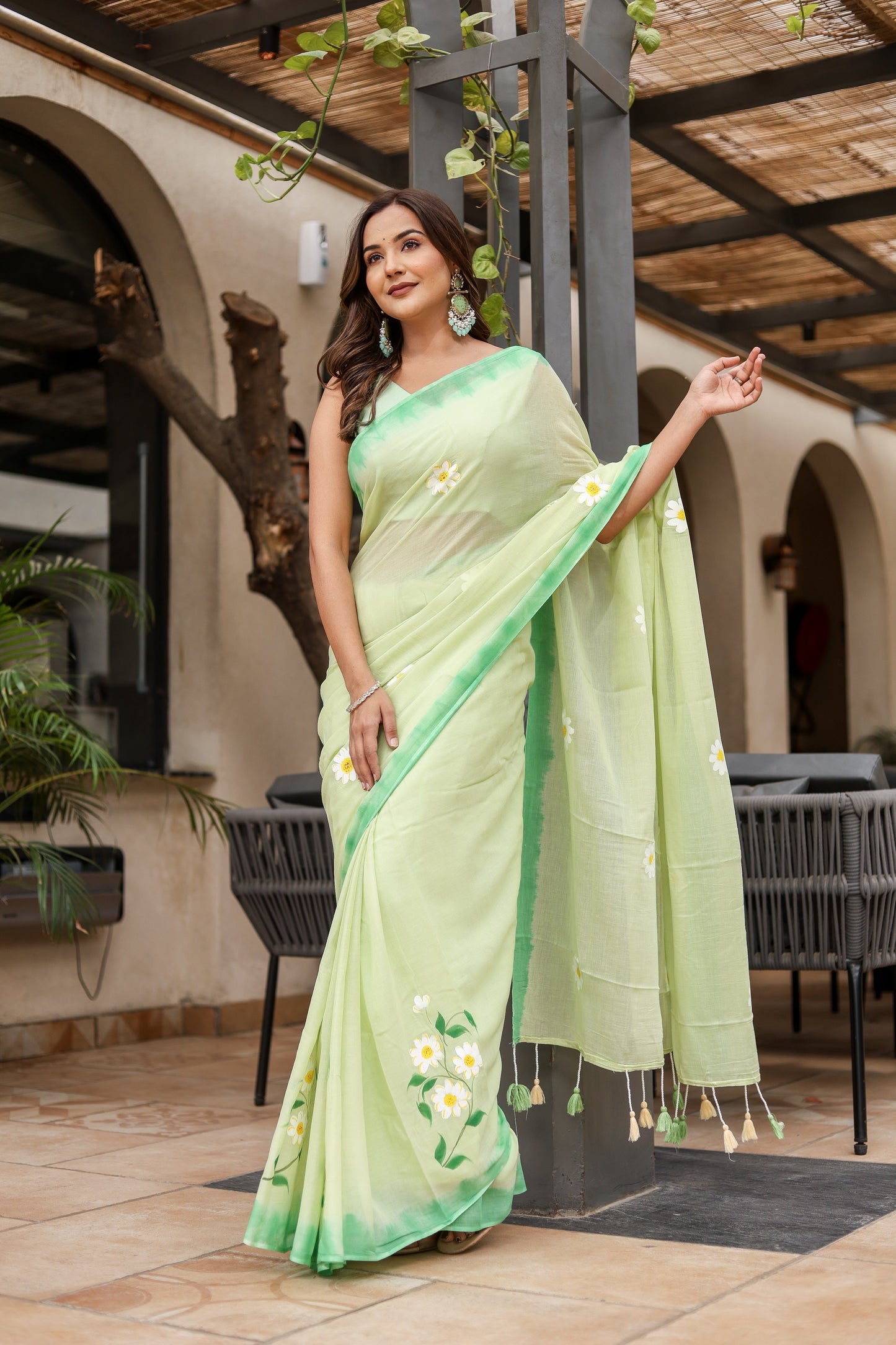Elegant designer malmal saree with flowers in green, perfect for special occasions and celebrations