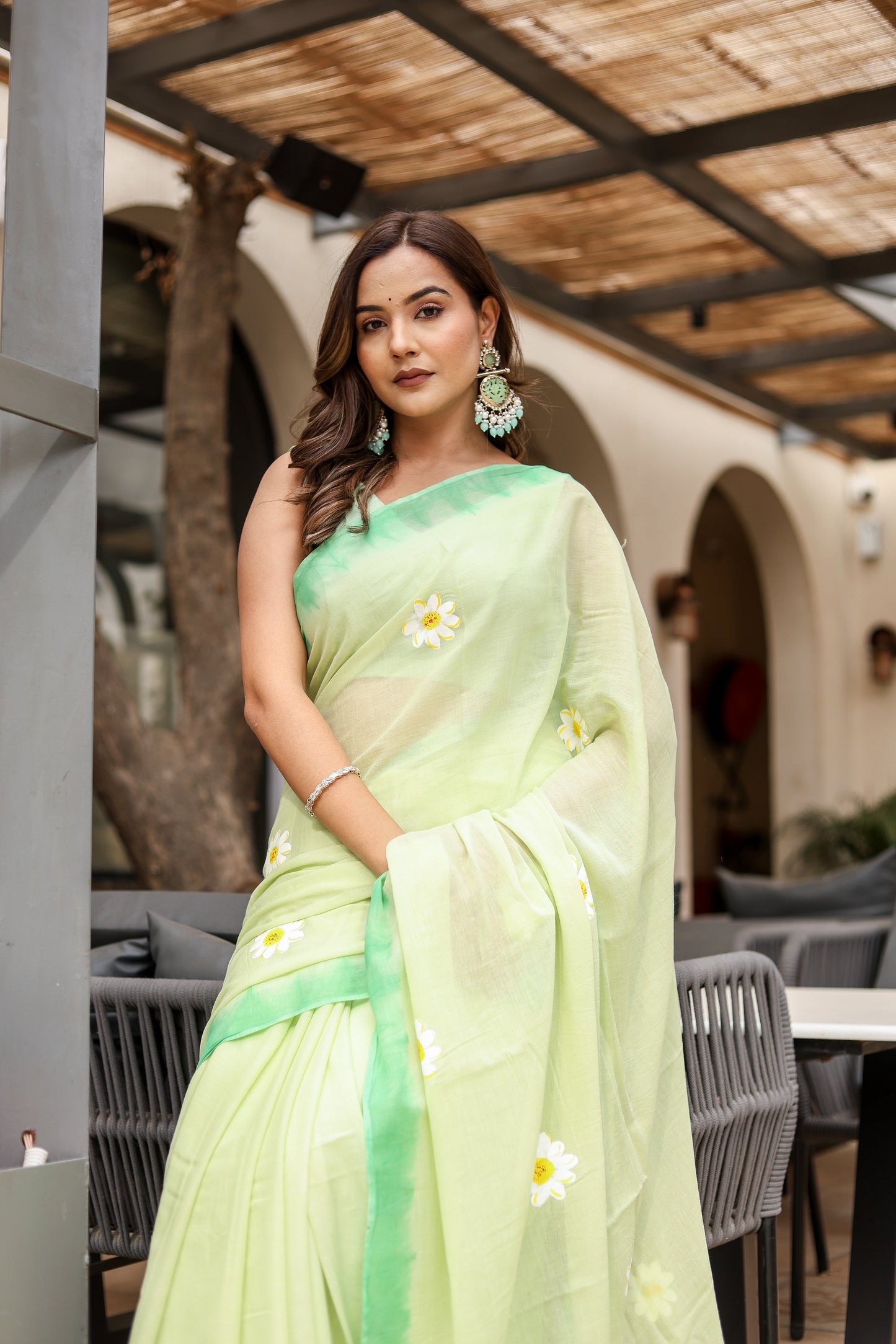 Stylera designer malmal saree with flowers in soft green featuring elegant floral embroidery