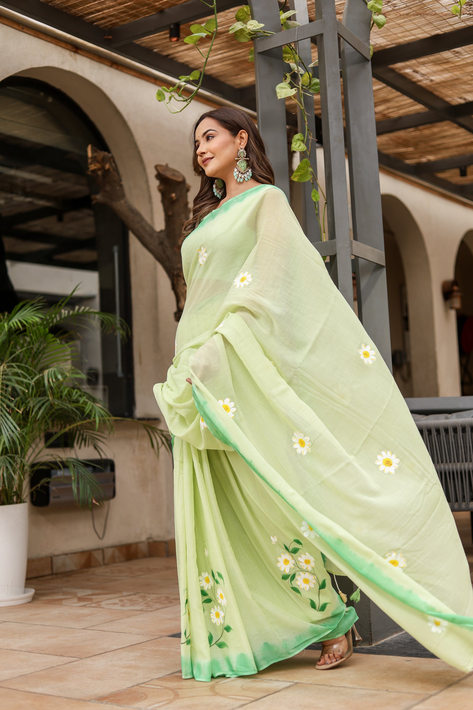 Stylera designer malmal saree with flowers in light green, featuring delicate floral embroidery