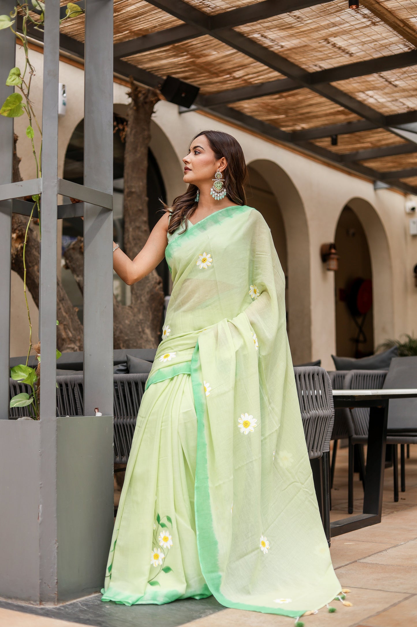 Light green designer malmal saree with flowers featuring elegant embroidery and soft draping