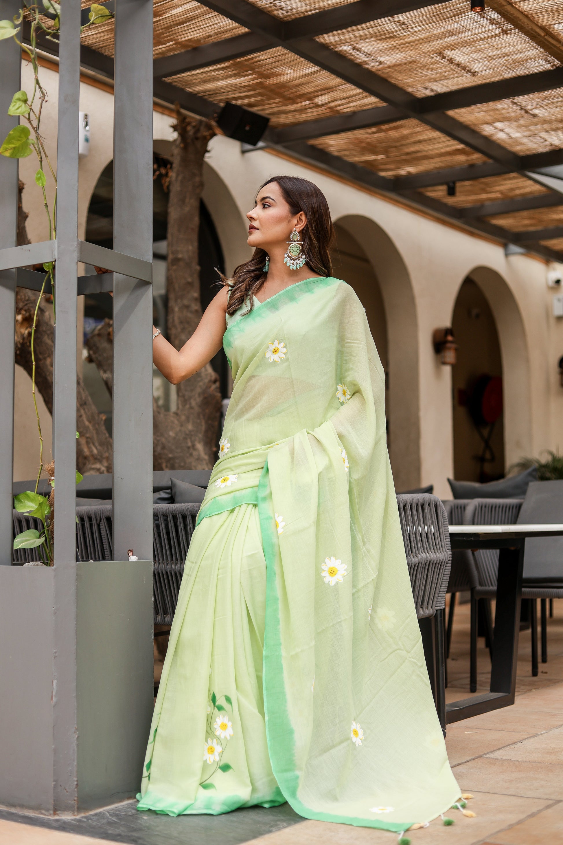 Light green designer malmal saree with flowers featuring elegant embroidery and soft draping