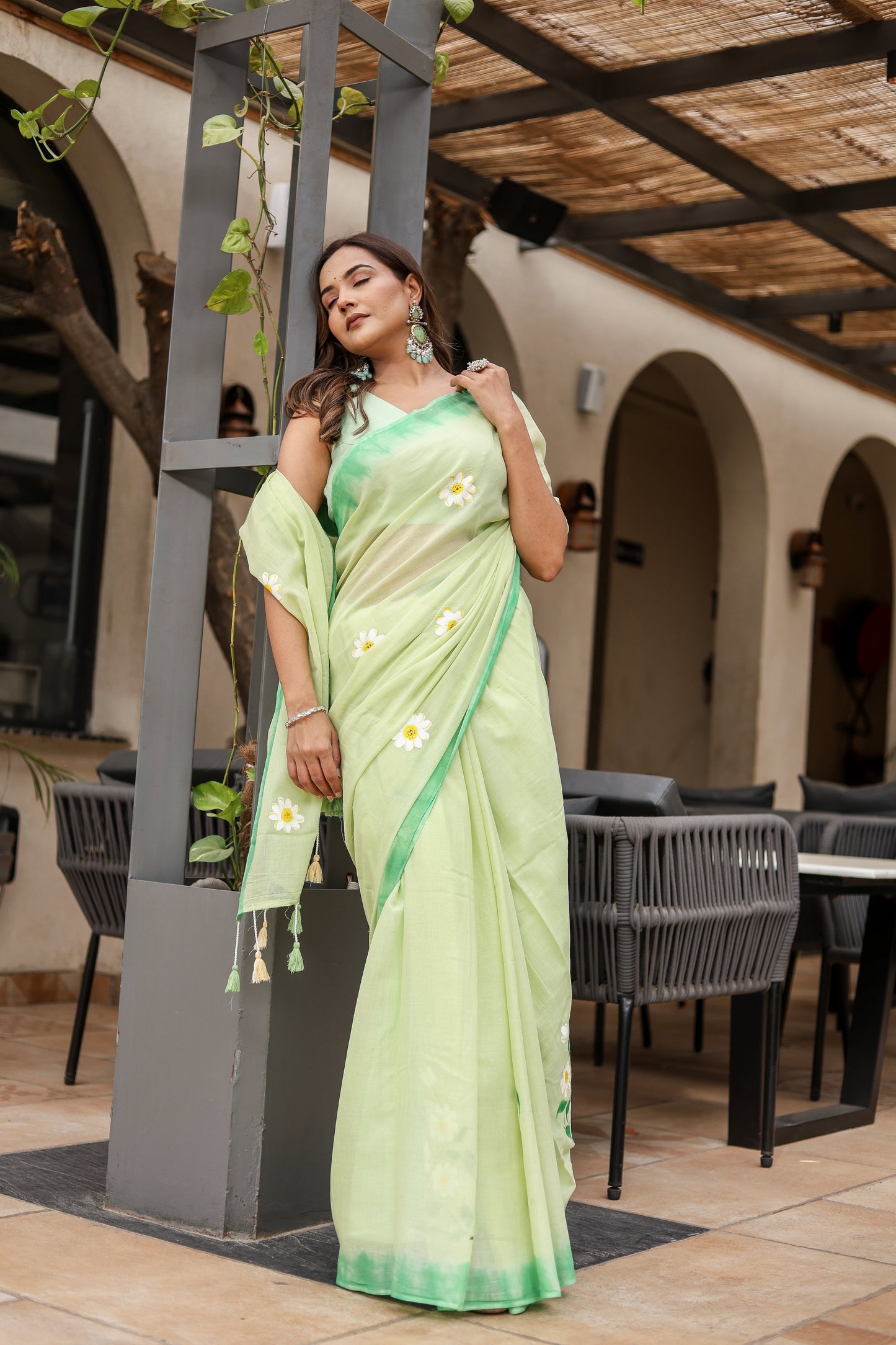 Elegant Stylera designer malmal saree with flowers in soft green, styled with matching accessories