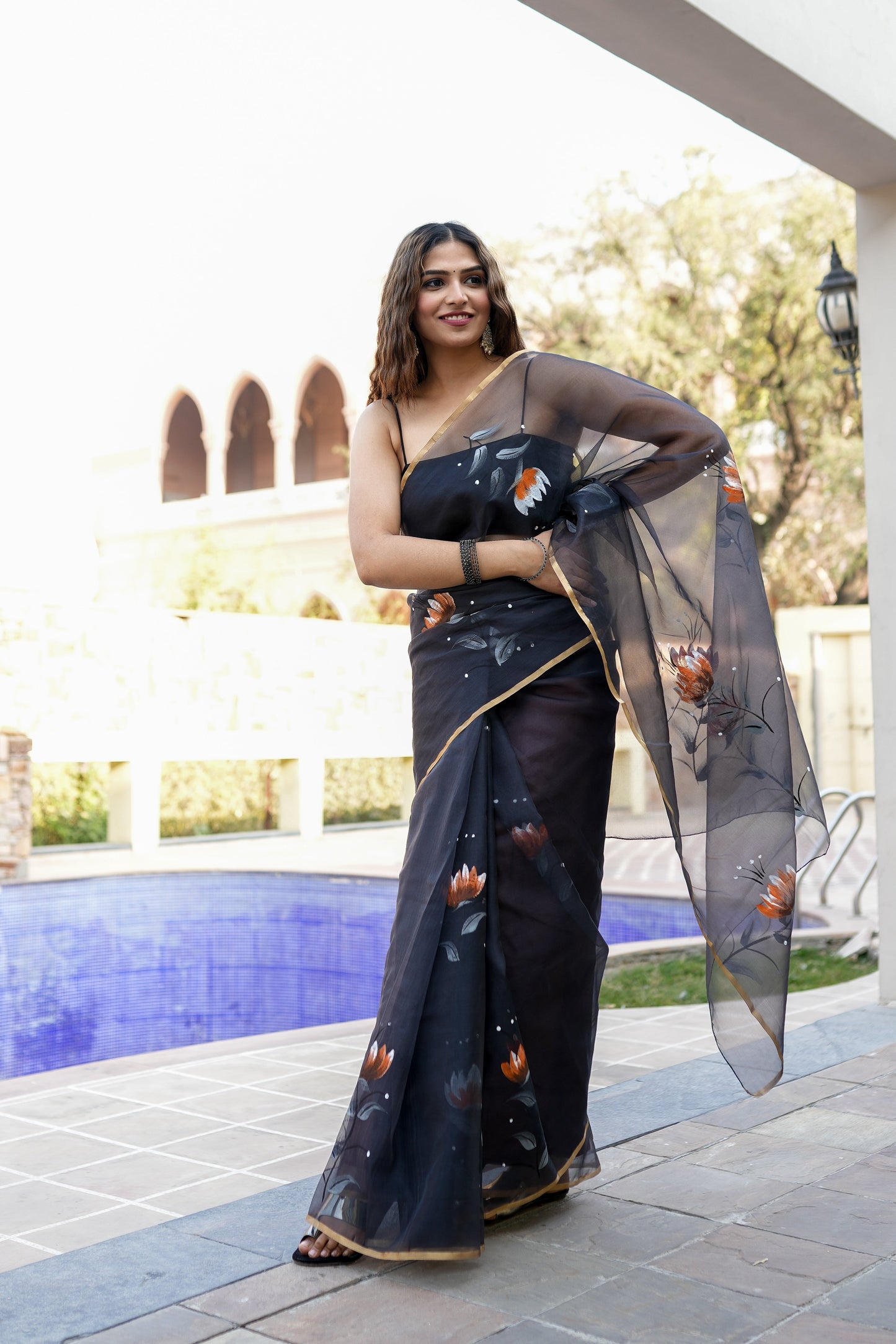 Elegant designer party wear saree for women with floral patterns and a sheer pallu, perfect for special occasions