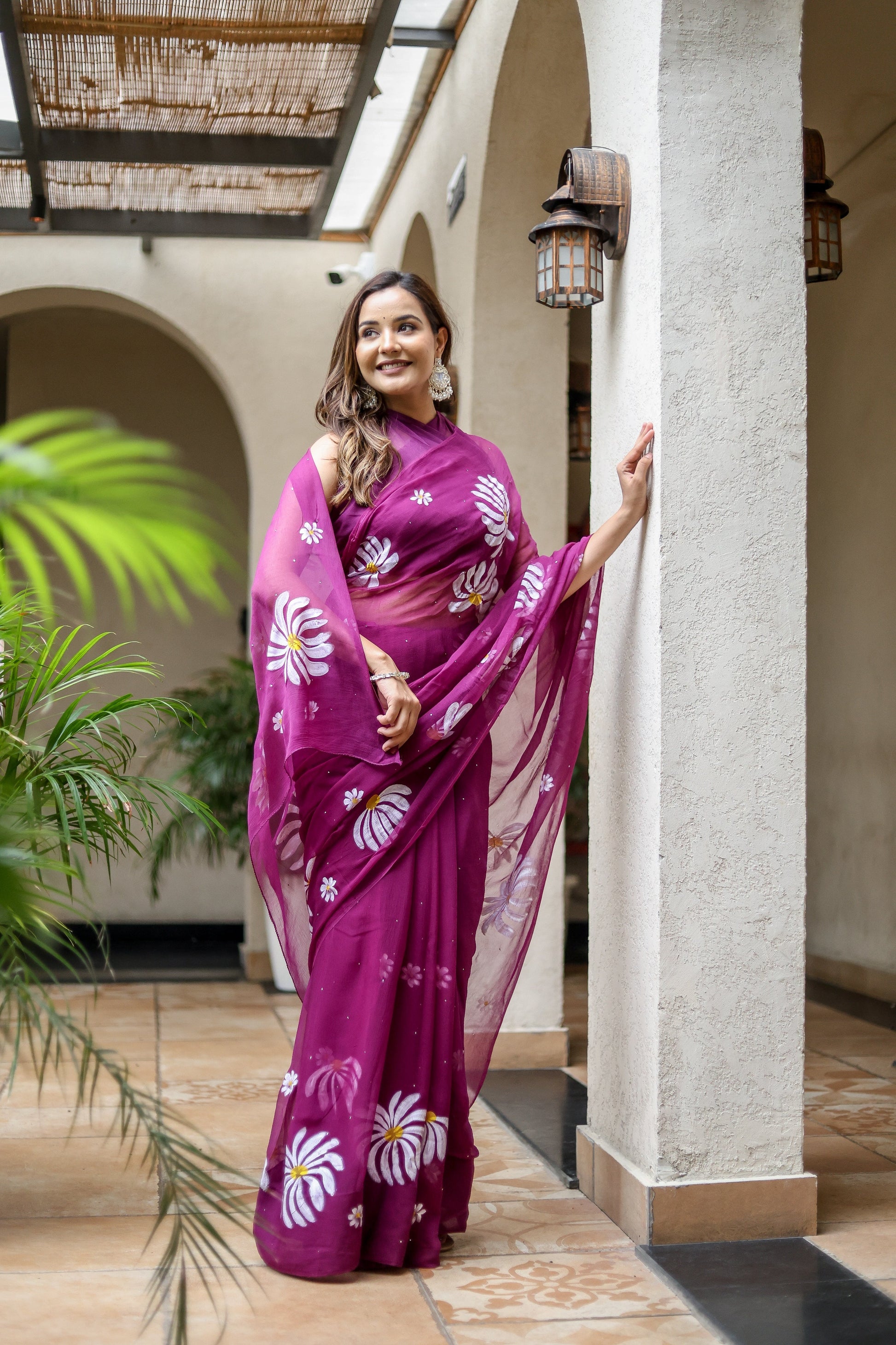 Elegant designer party wear saree for women in vibrant purple with floral embroidery details