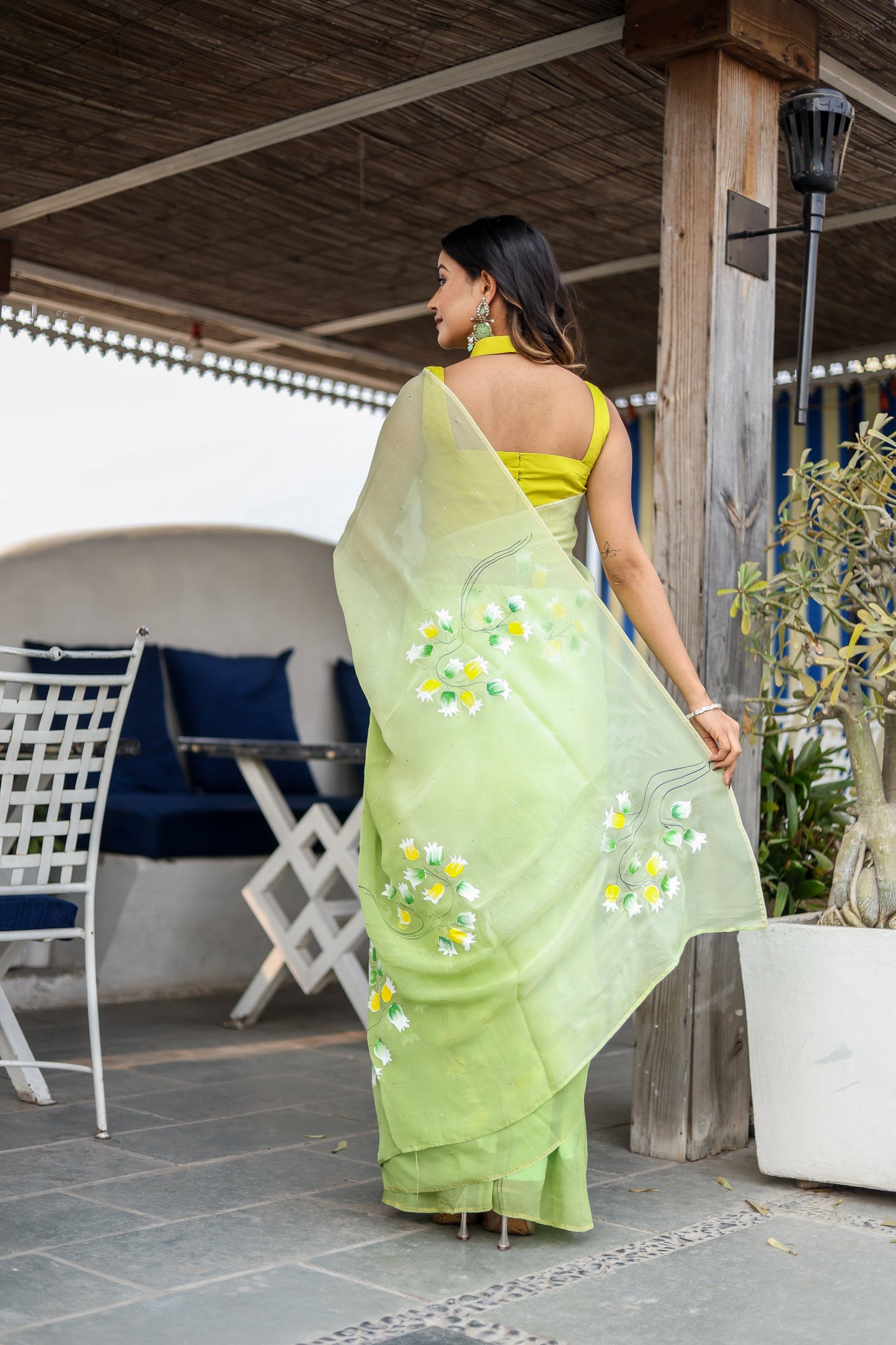 Elegant designer party wear saree in green with floral embroidery, paired with a matching blouse