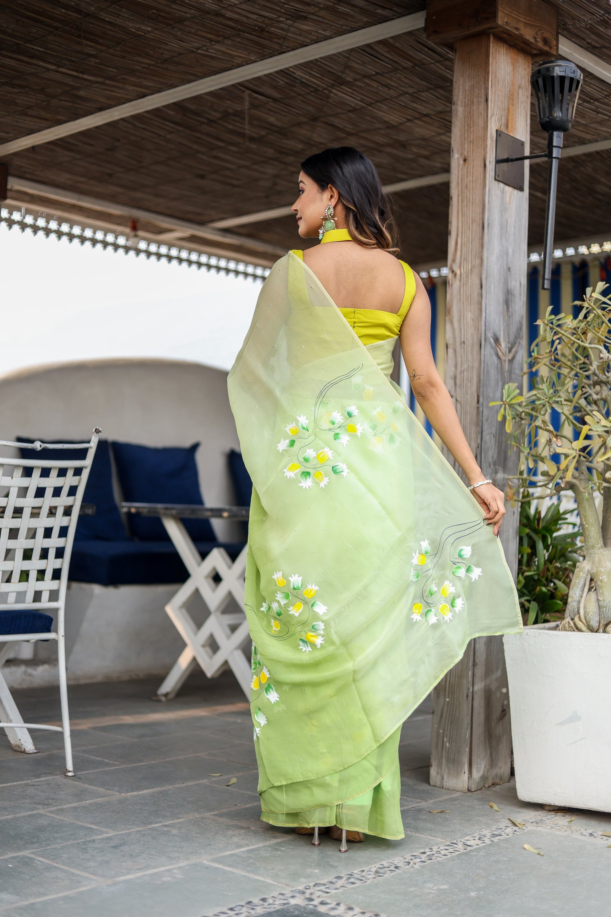 Elegant designer party wear saree in green with floral embroidery, paired with a matching blouse