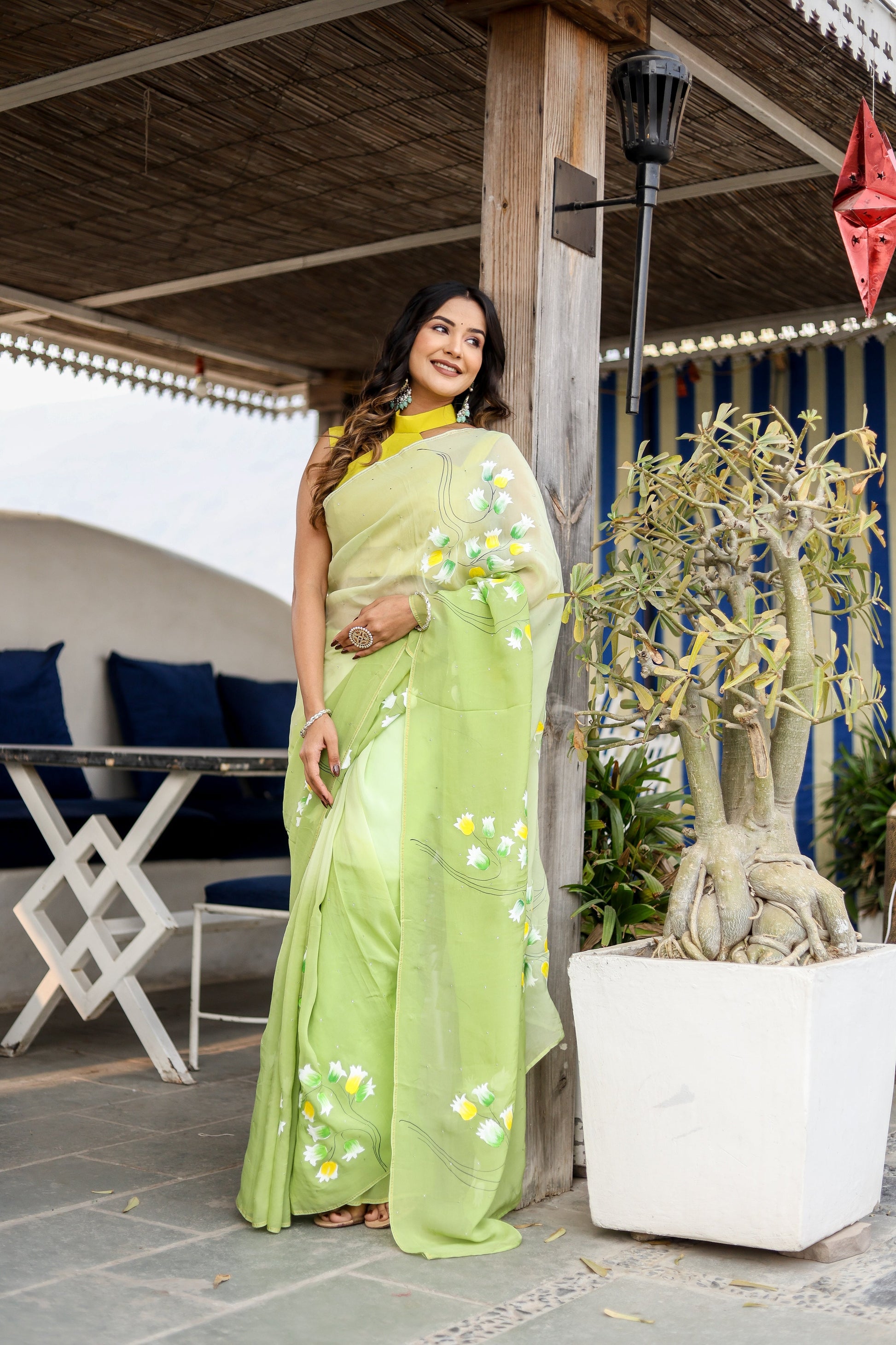 Stylera designer party wear saree in light green with floral embroidery, styled for modern celebrations