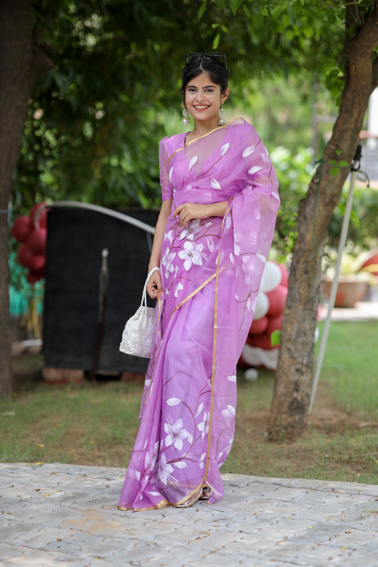 Elegant designer saree for special occasions in purple with floral patterns, styled for a festive look