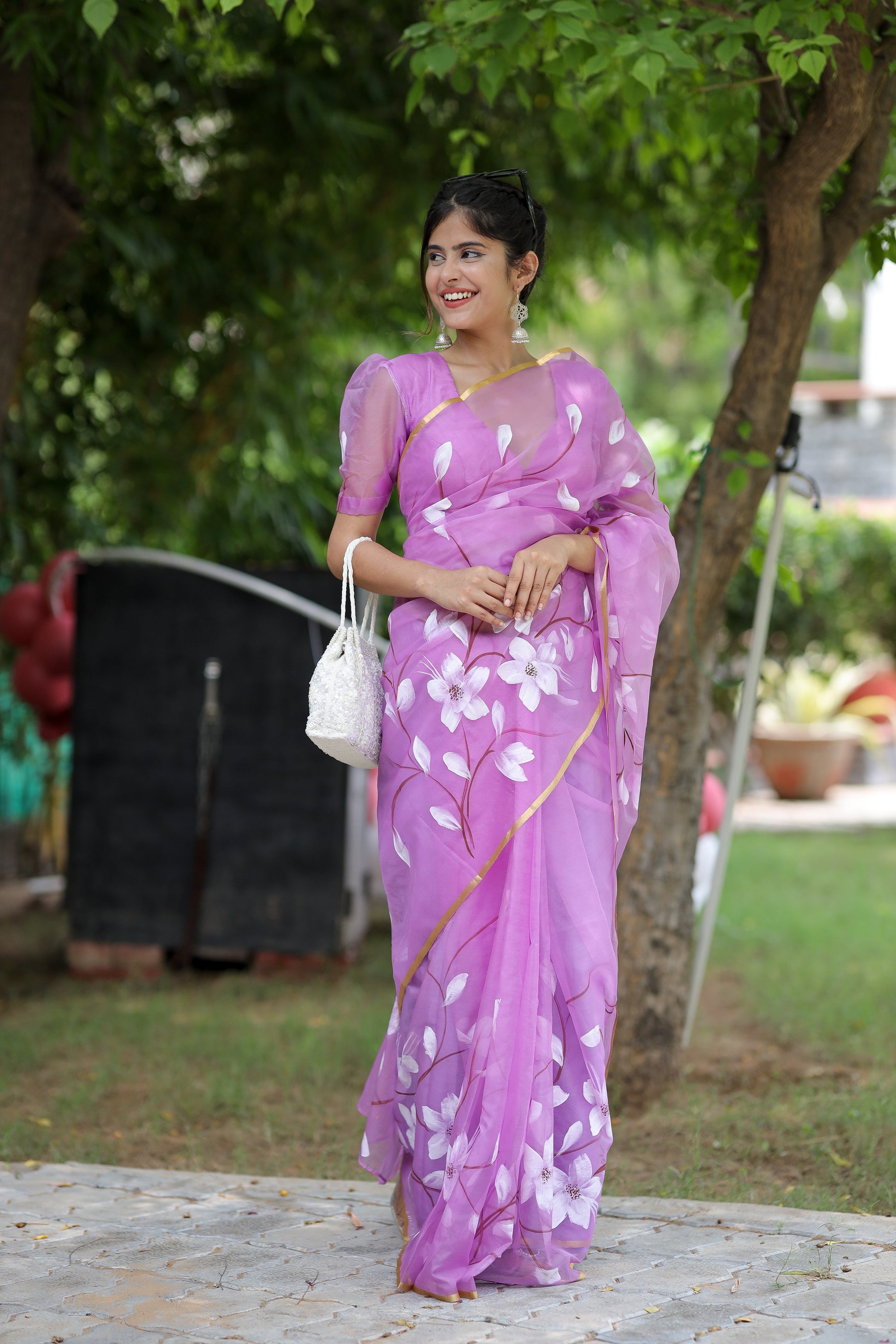 Elegant pink designer saree for special occasions with floral patterns, perfect for festive celebrations