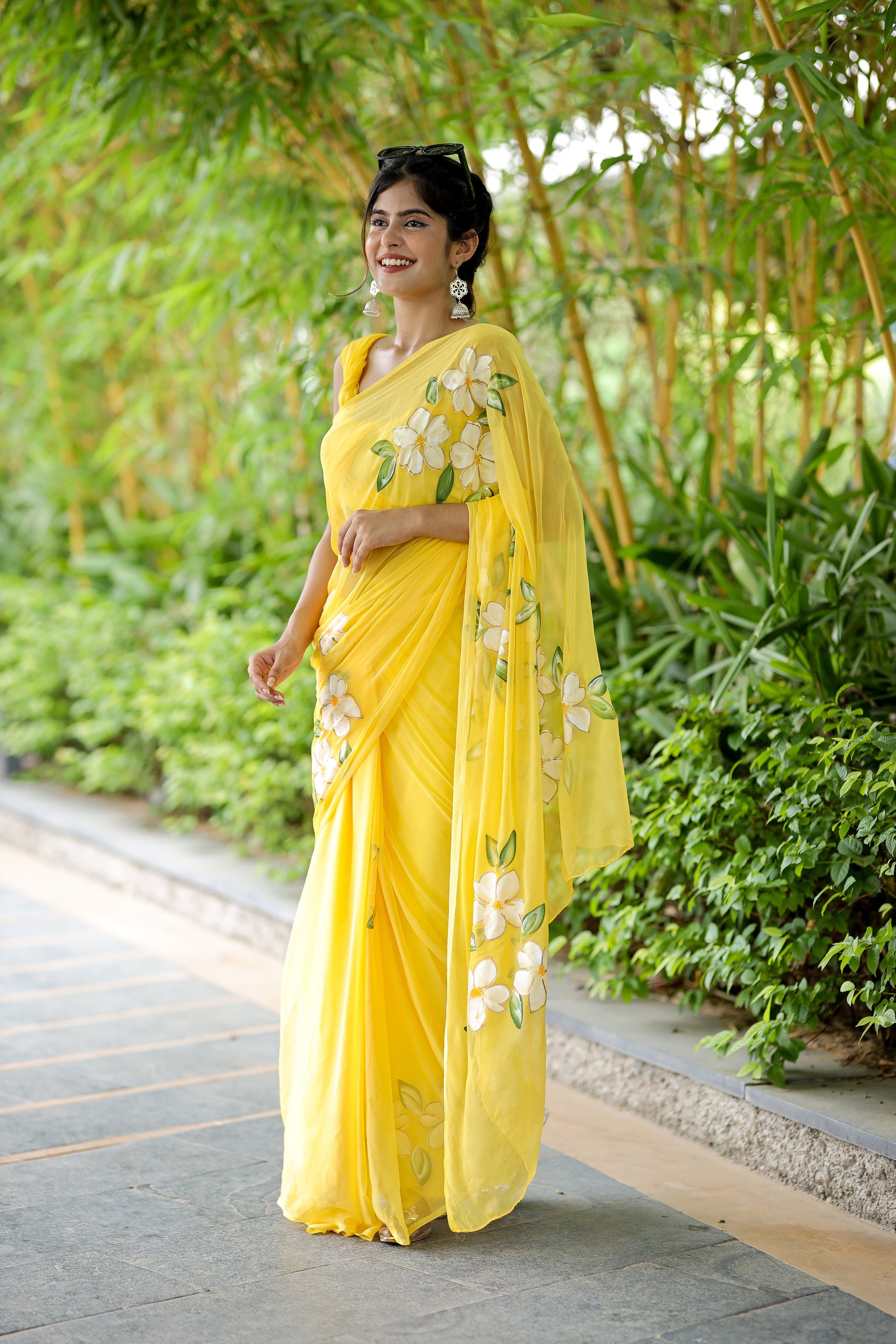 Elegant yellow designer saree with floral art, perfect for festive occasions and special events