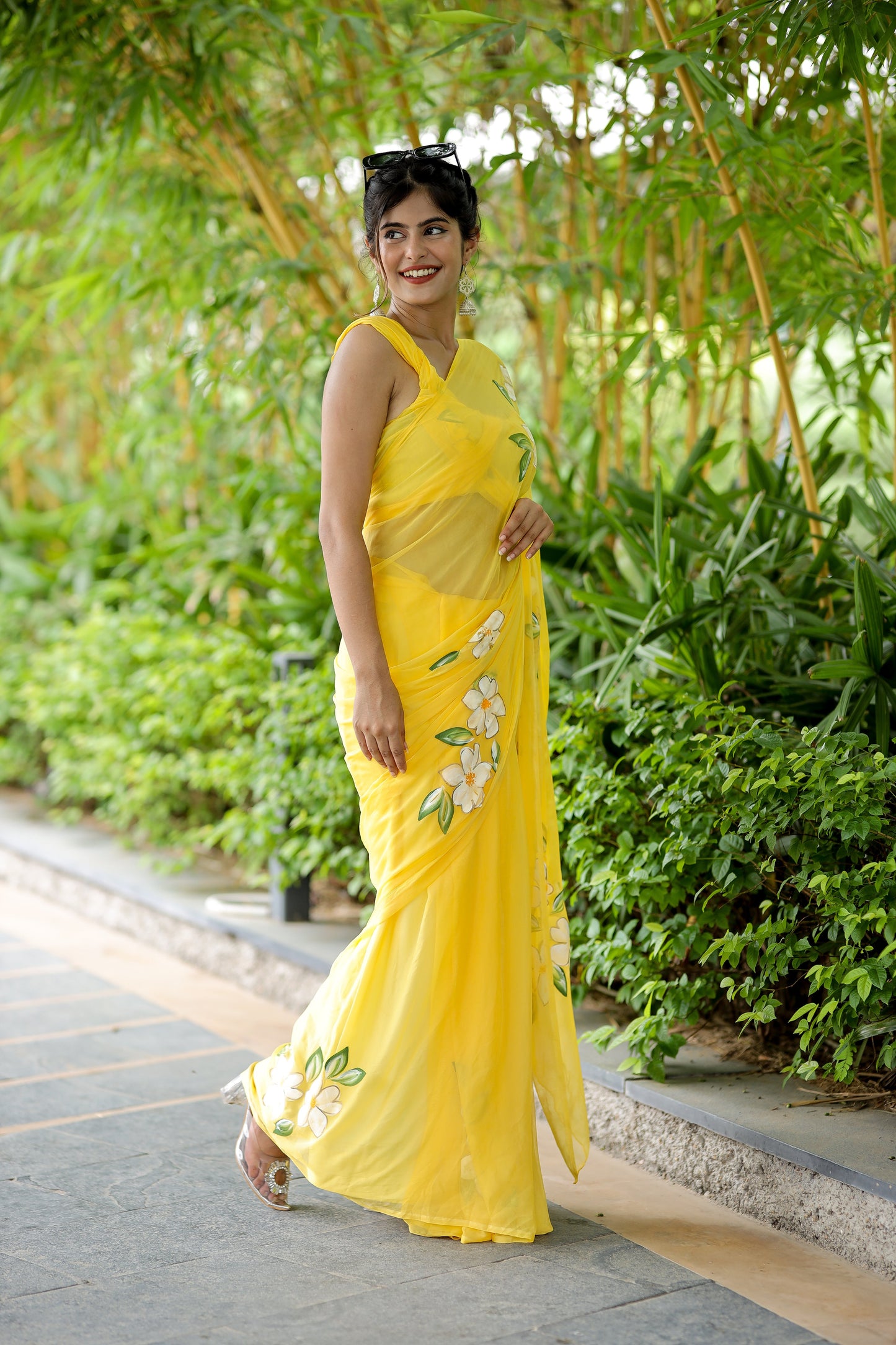 Bright yellow designer saree with floral art, ideal for festive occasions and celebrations