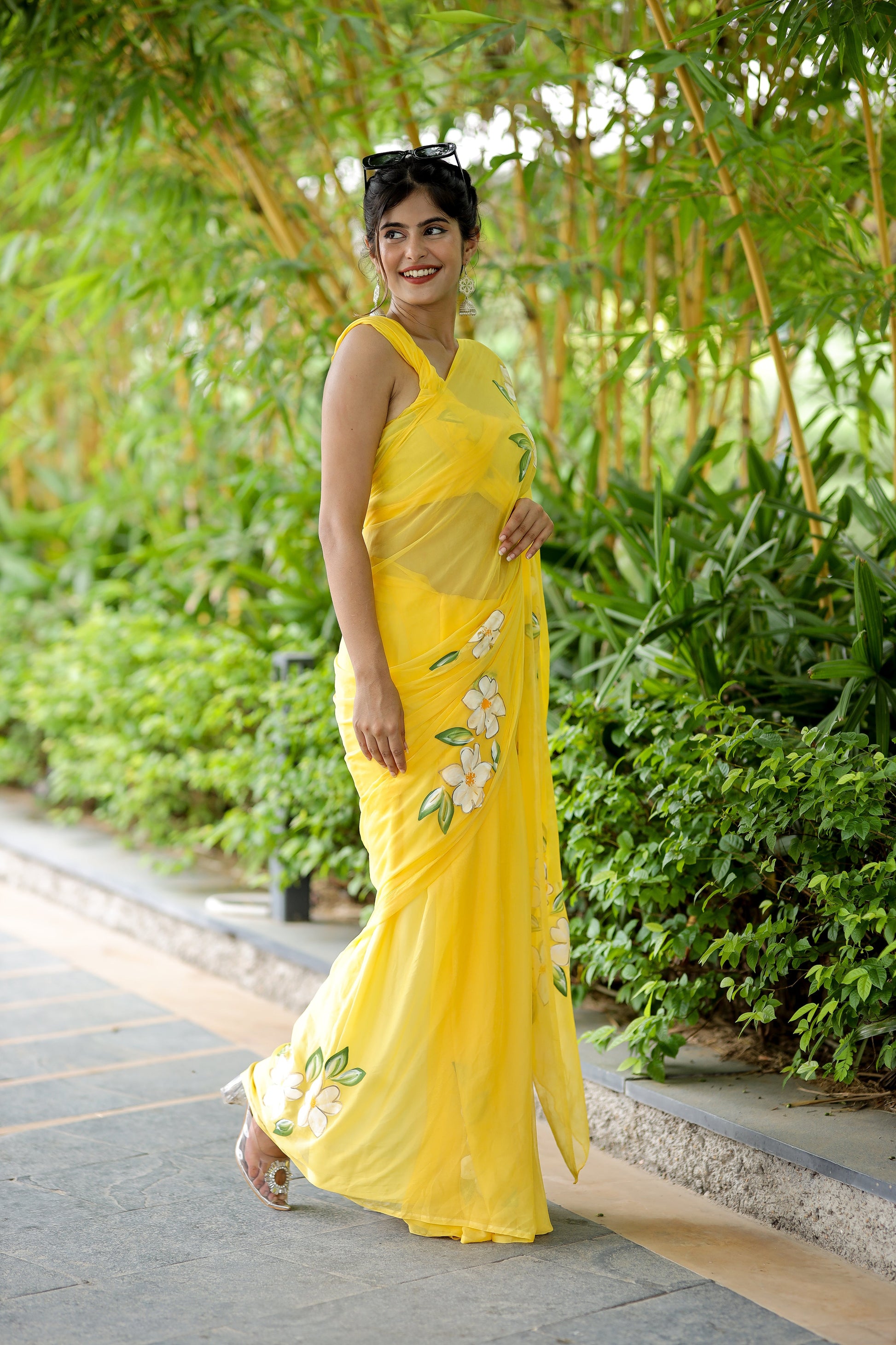 Bright yellow designer saree with floral art, ideal for festive occasions and celebrations