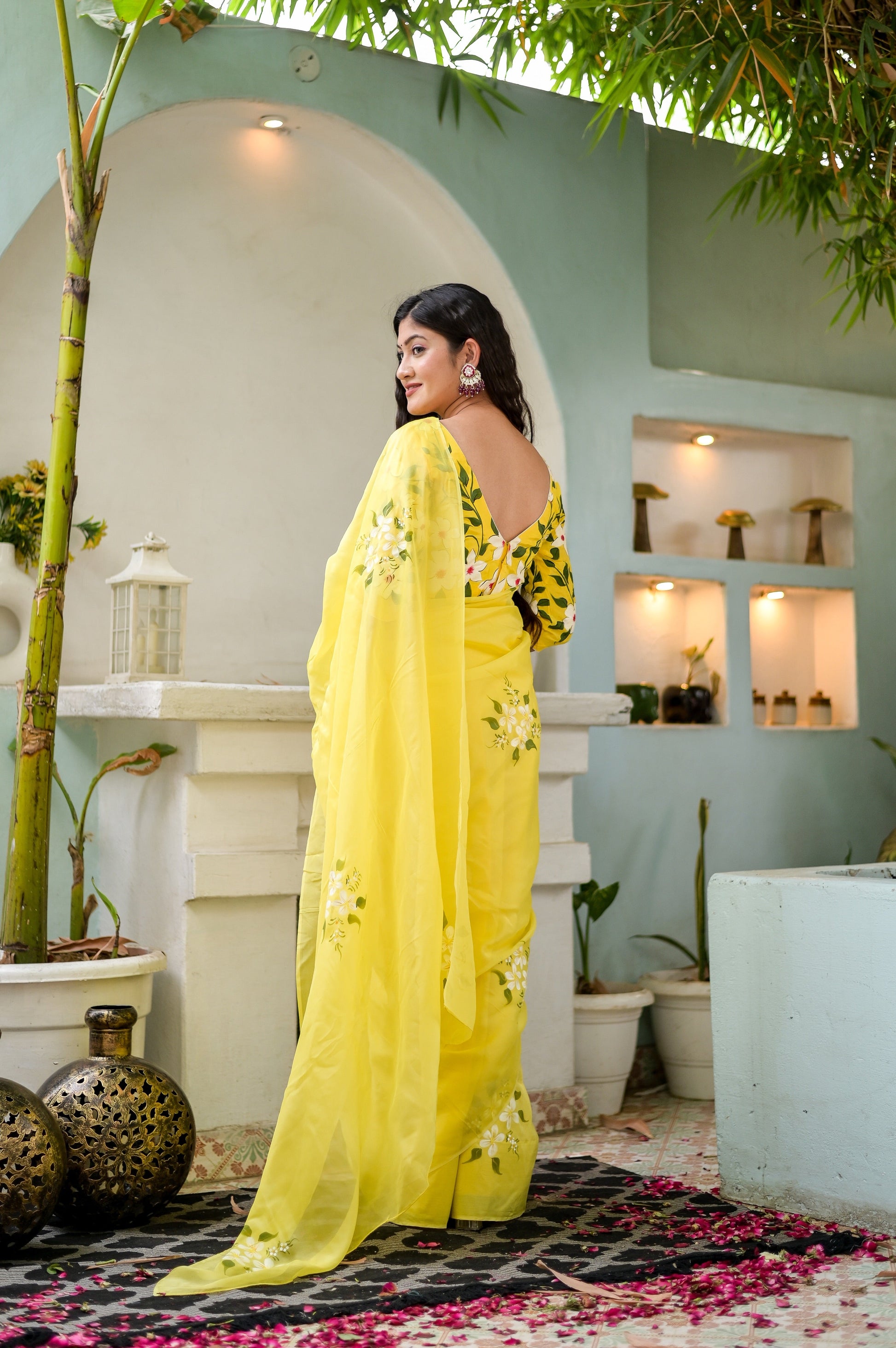 Stunning designer yellow saree hand painted, showcasing intricate floral details for elegant occasions