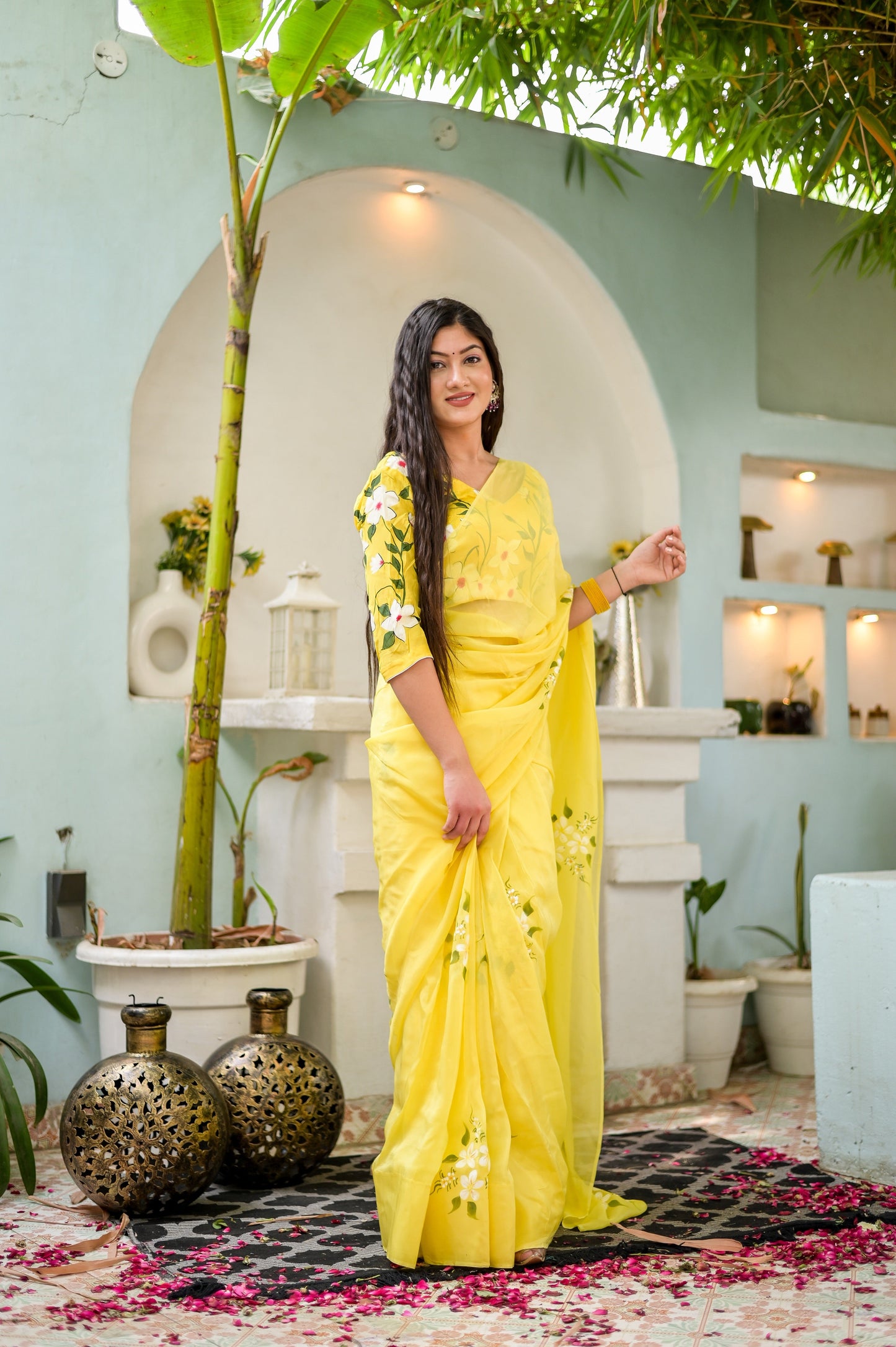 Elegant designer yellow saree hand painted with floral designs, perfect for festive occasions