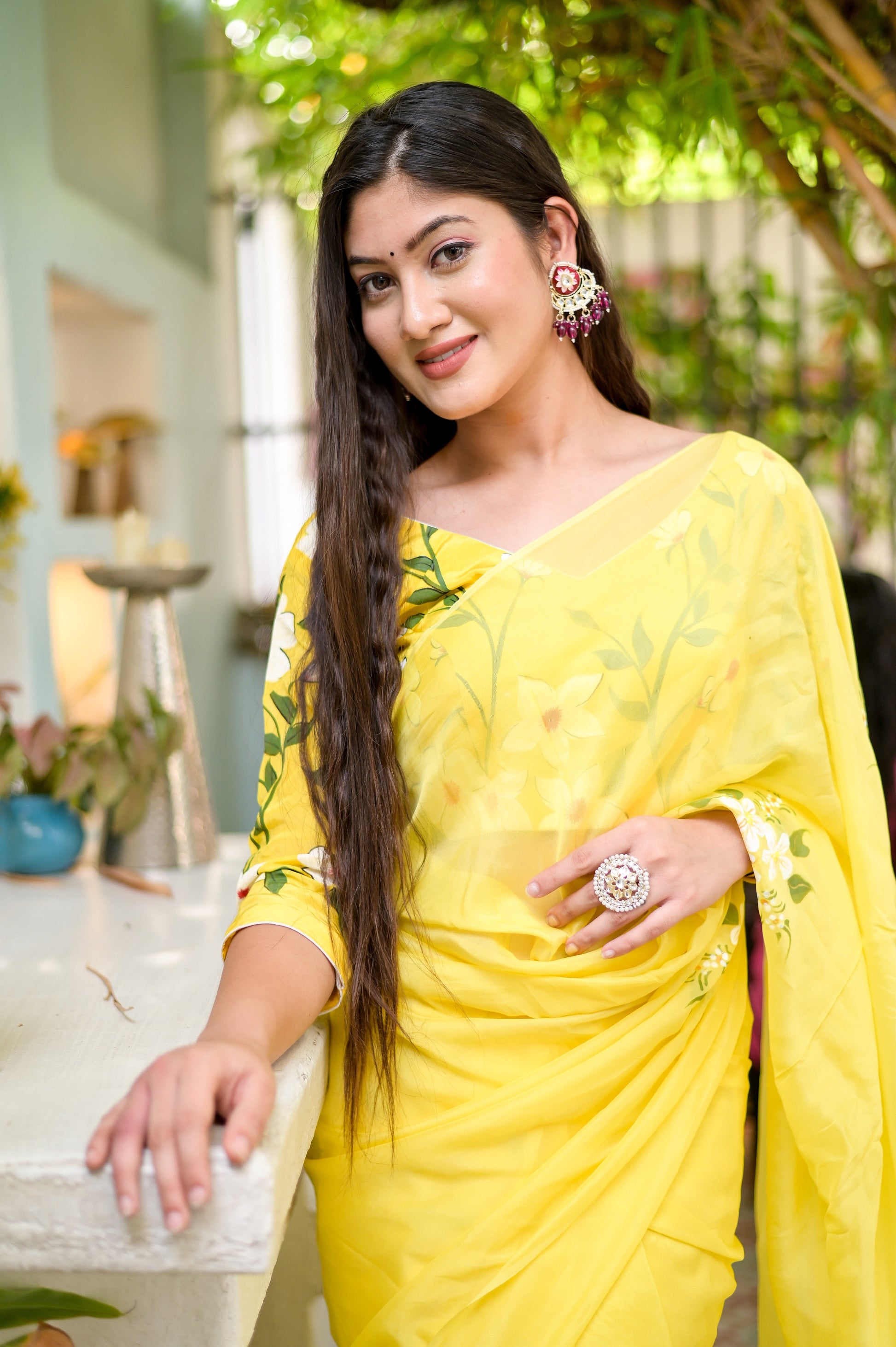 Model wearing a designer yellow saree hand painted with floral patterns for a vibrant look